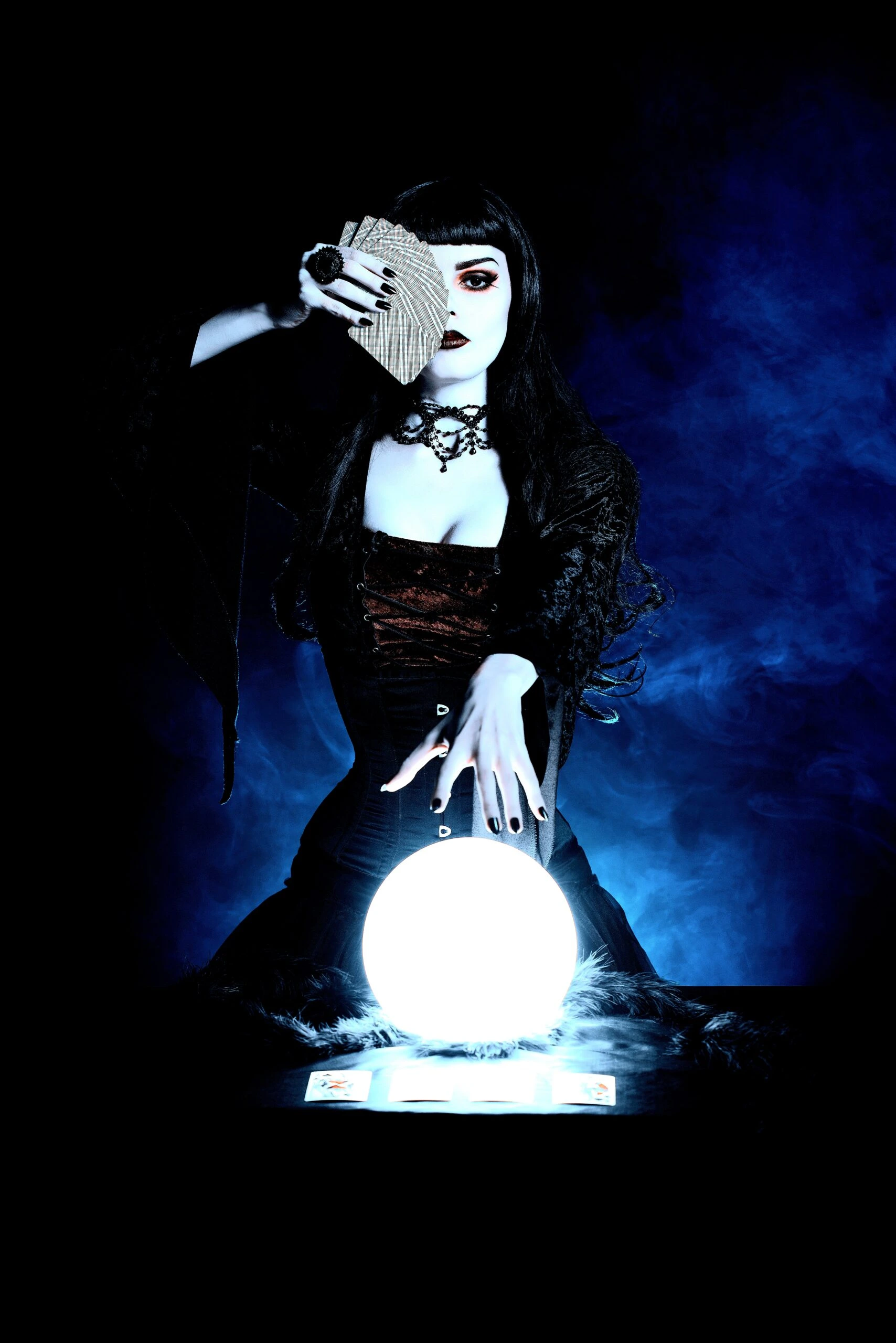 gothich witch doing a ritual with a crystal ball