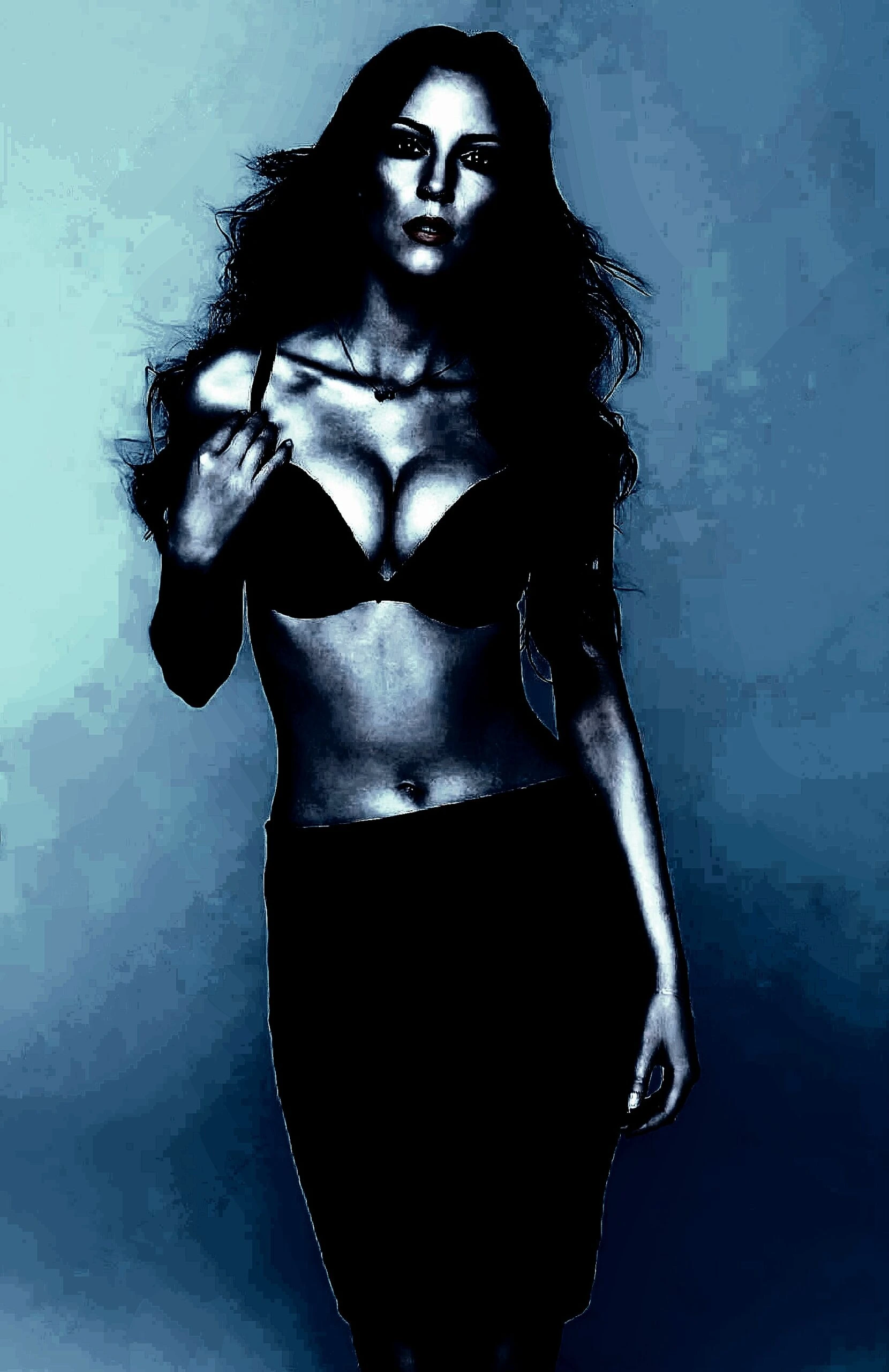 Woman with long hair in a black bra and skirt, posed with a confident gaze, emphasizing her bold and mysterious look.