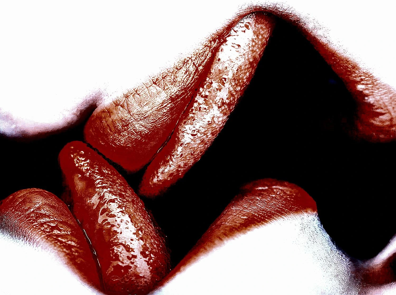 Close-up of two sets of lips lightly touching in a suggestive kiss.