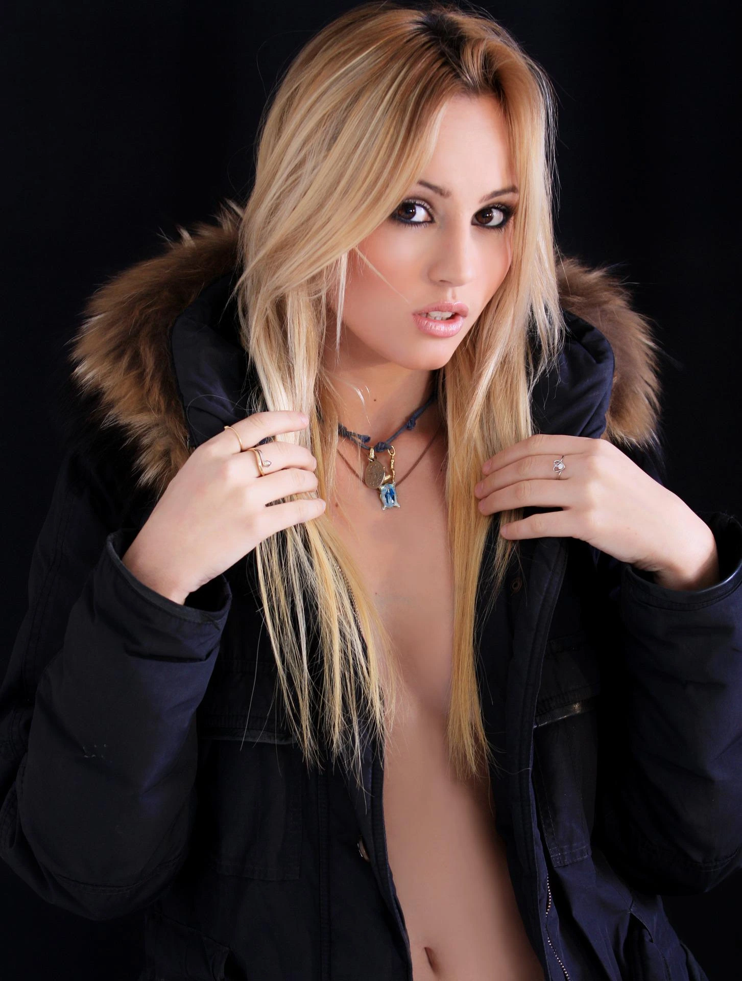 A blonde woman in a black jacket with gothic jewelry, representing the modern adaptation of gothic style in everyday wear.
