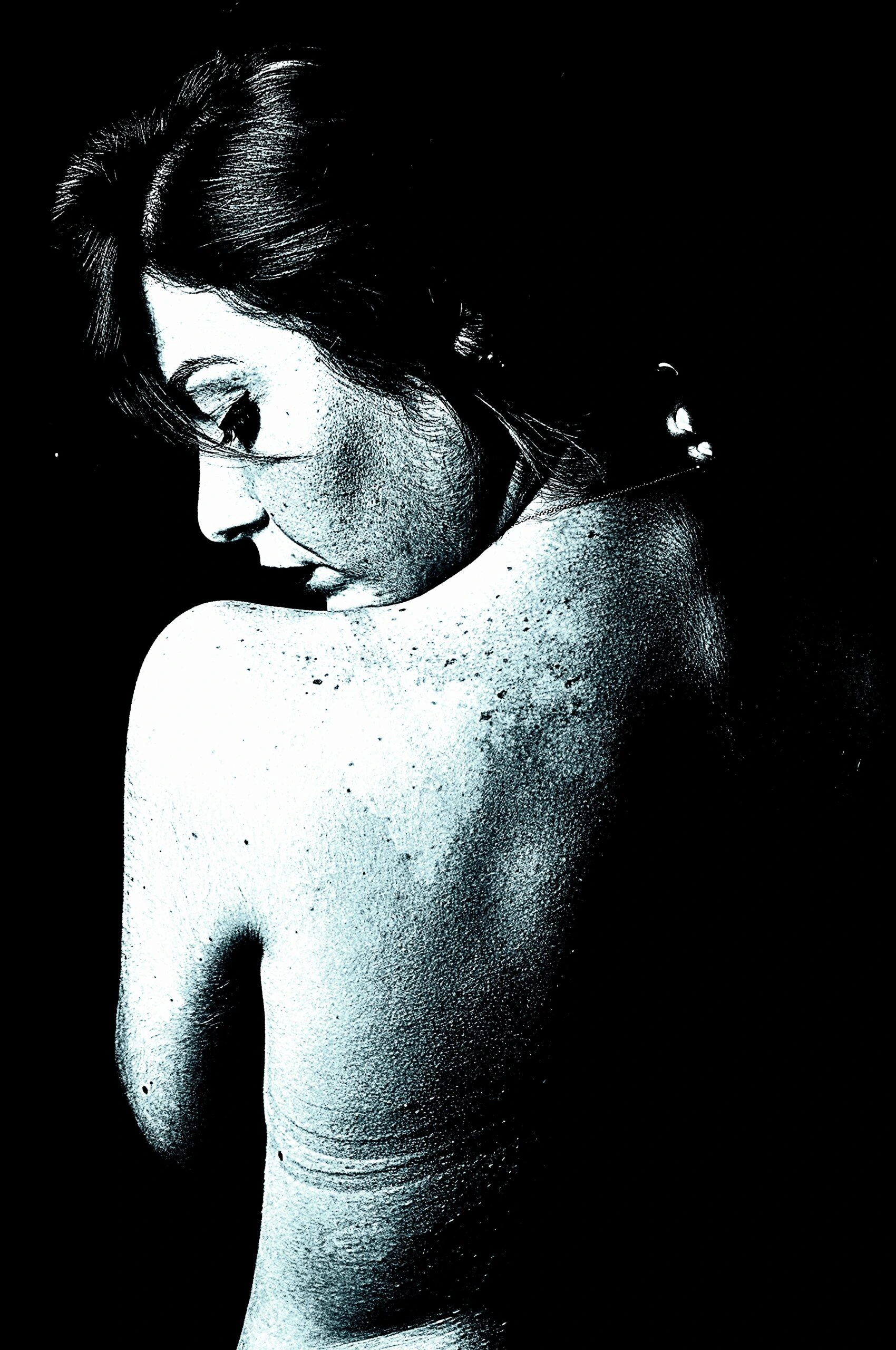 Introspective back view of a woman, hinting at introspection beyond the 'red flags in a woman'.