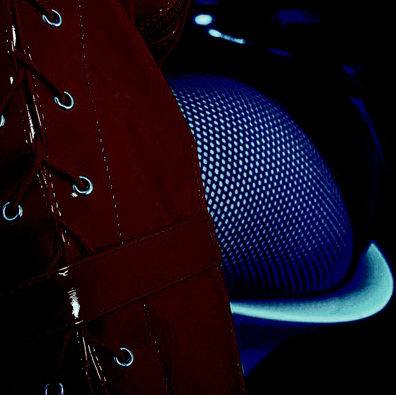 A grayscale image of a person's legs in fishnet stockings, crossed and elevated, against a muted background, suggesting seduction and anticipation.