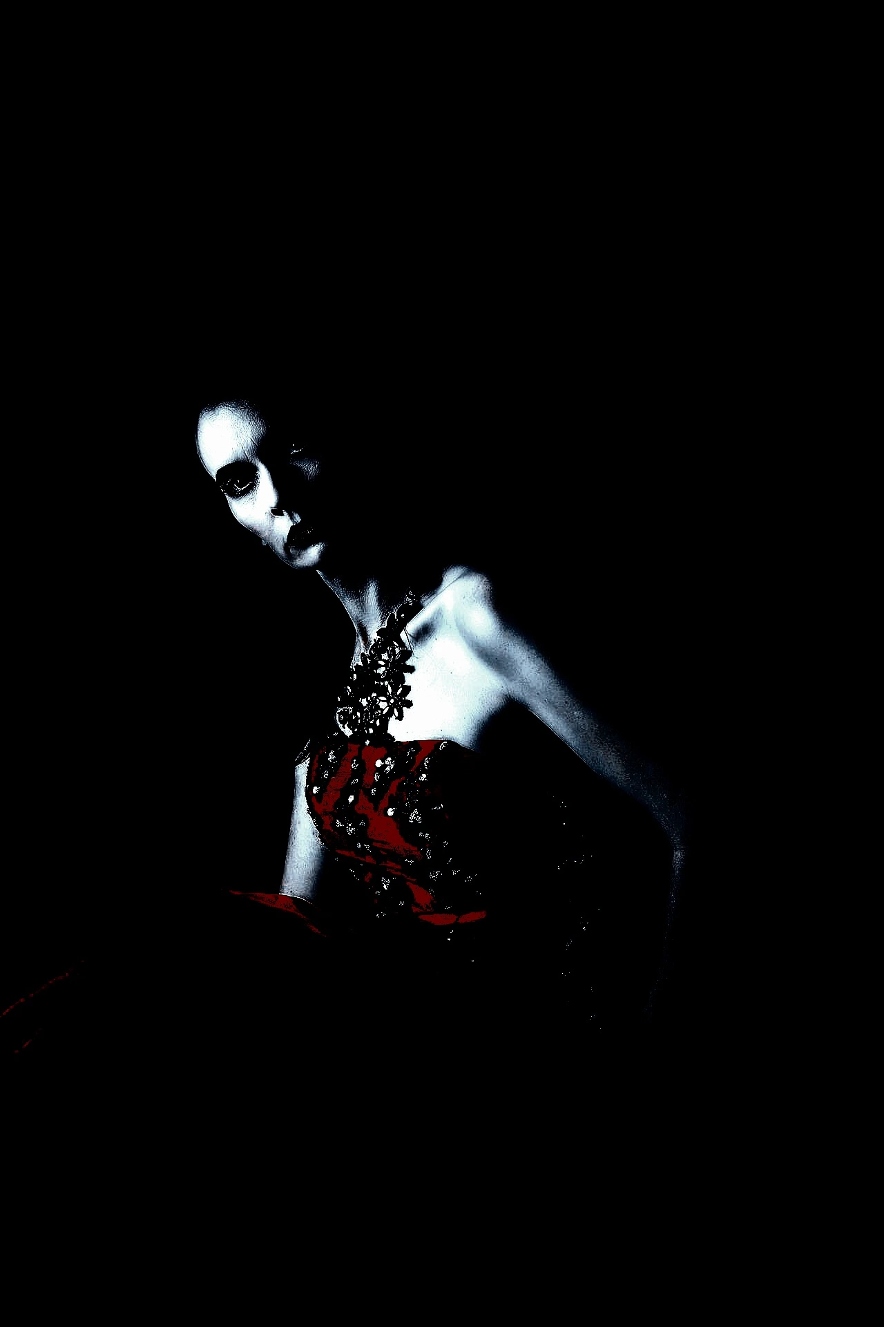 A pensive gothic figure sitting in darkness with a subtle red accent on the lips, surrounded by night, creating an atmosphere of introspective solitude.