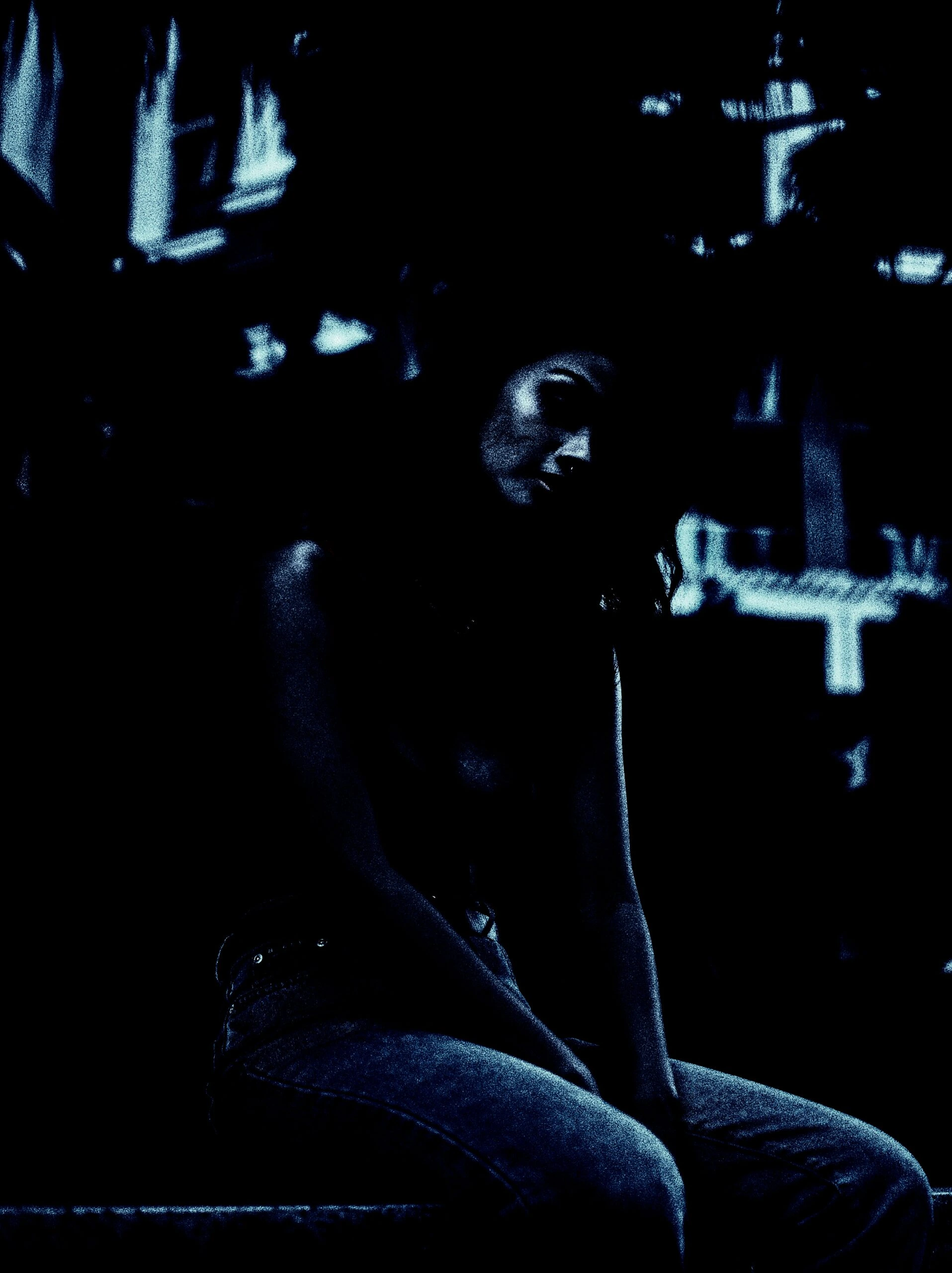 Dark and moody image of a woman seated alone, illustrating the solitude associated with 'red flags in a woman'.