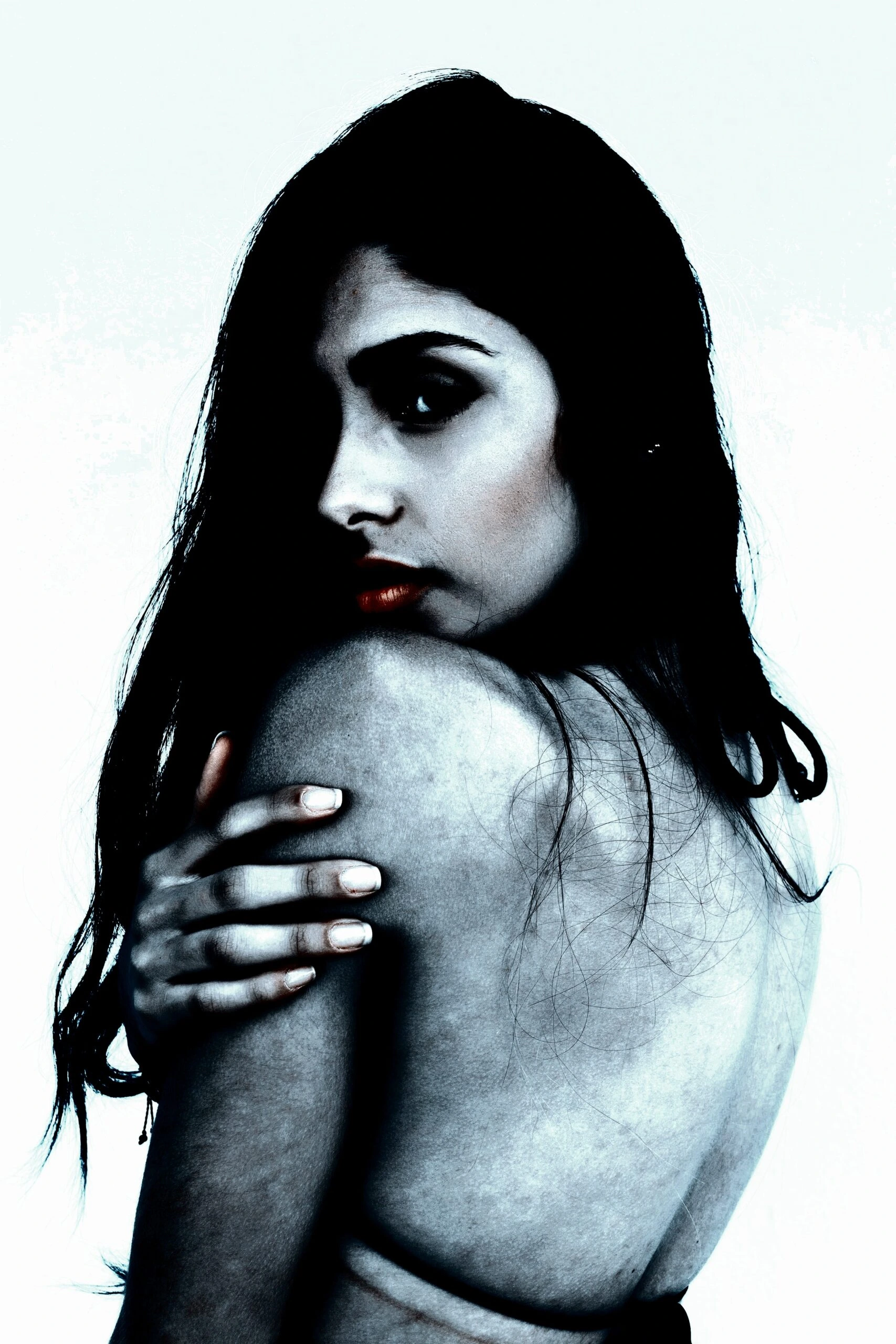 A woman’s silhouette in a contemplative pose, suggesting introspection and the hidden 'red flags in a woman'.