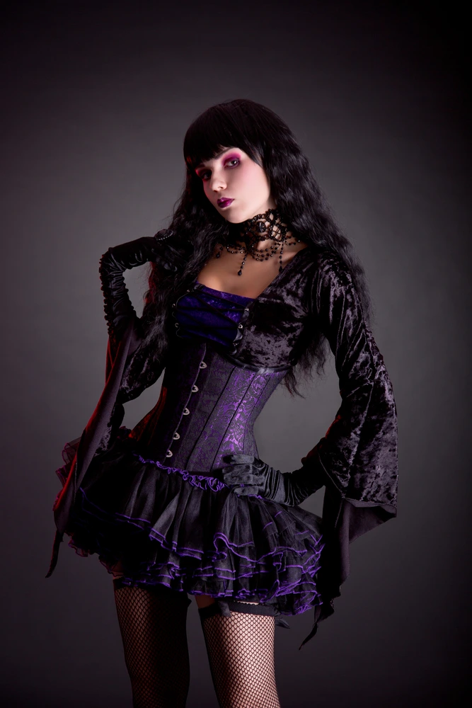 Majestic gothic model with a raven black hairstyle and a velvet corset dress, creating a striking silhouette against a red-hued smoke backdrop.