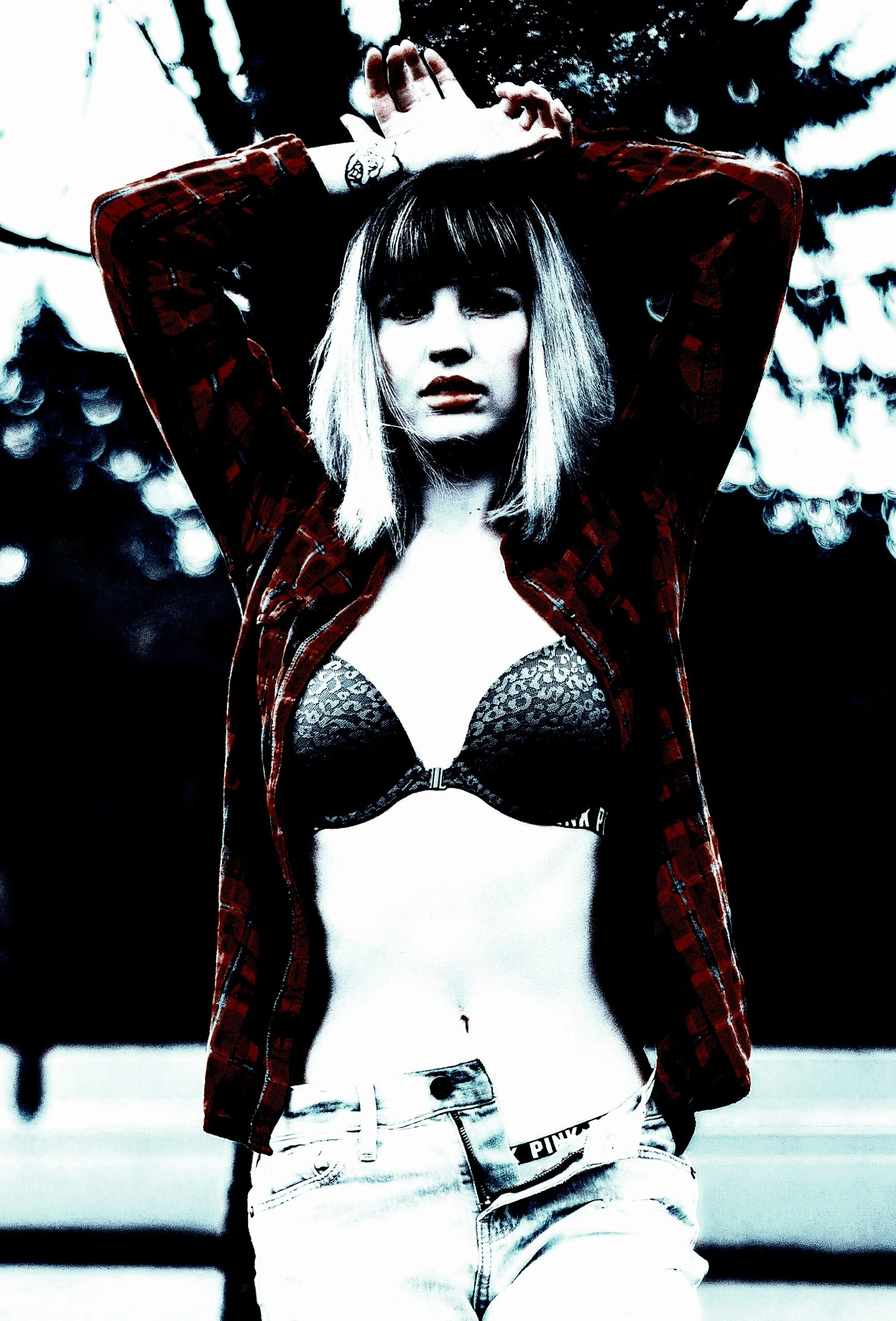 Edgy woman in red flannel and lingerie, exuding confidence and challenging 'red flags in a woman' stereotypes.