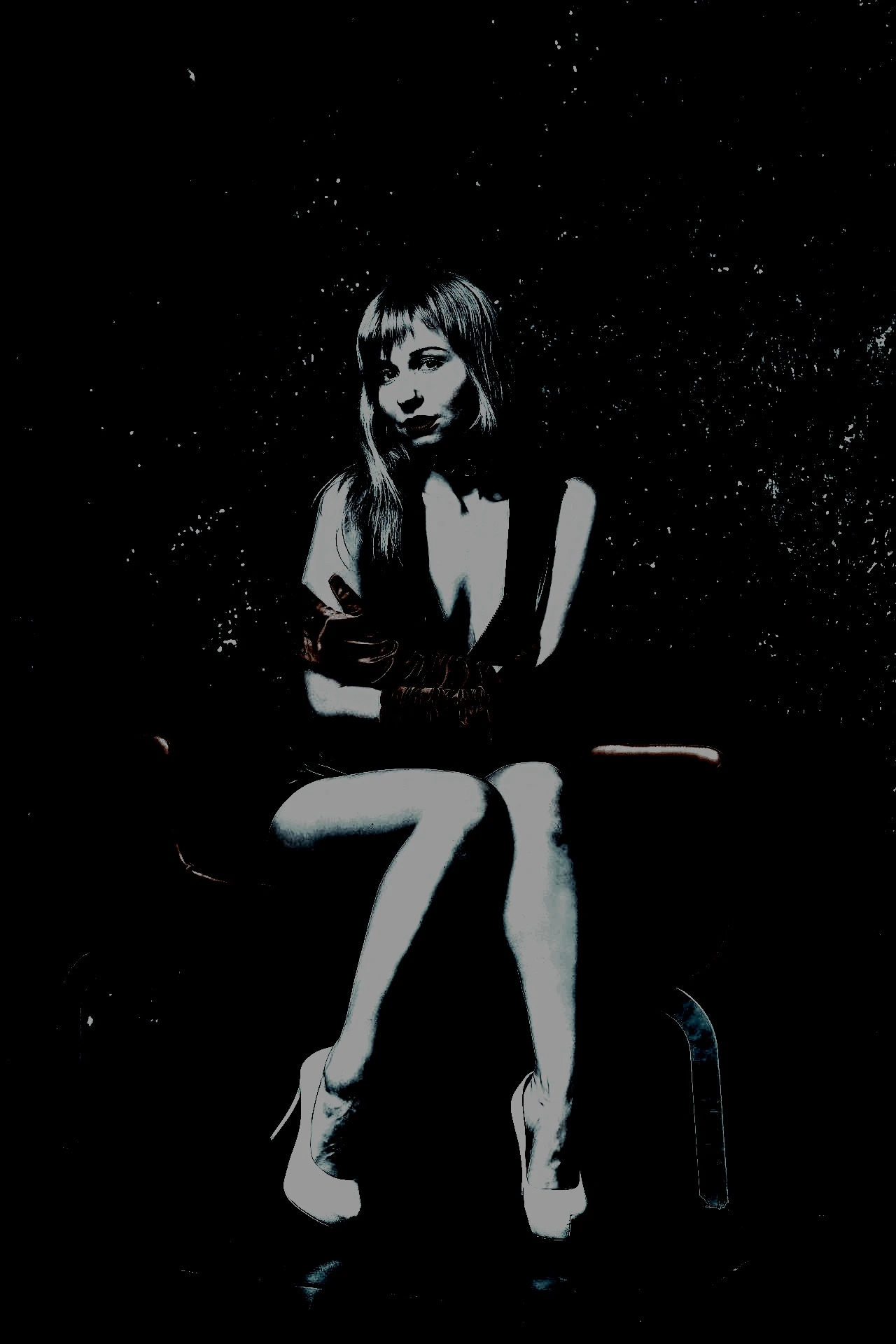 seated woman in leather attire: "Elegant woman seated in a provocative leather outfit, emphasizing the psychological dynamics of dominance and submission.