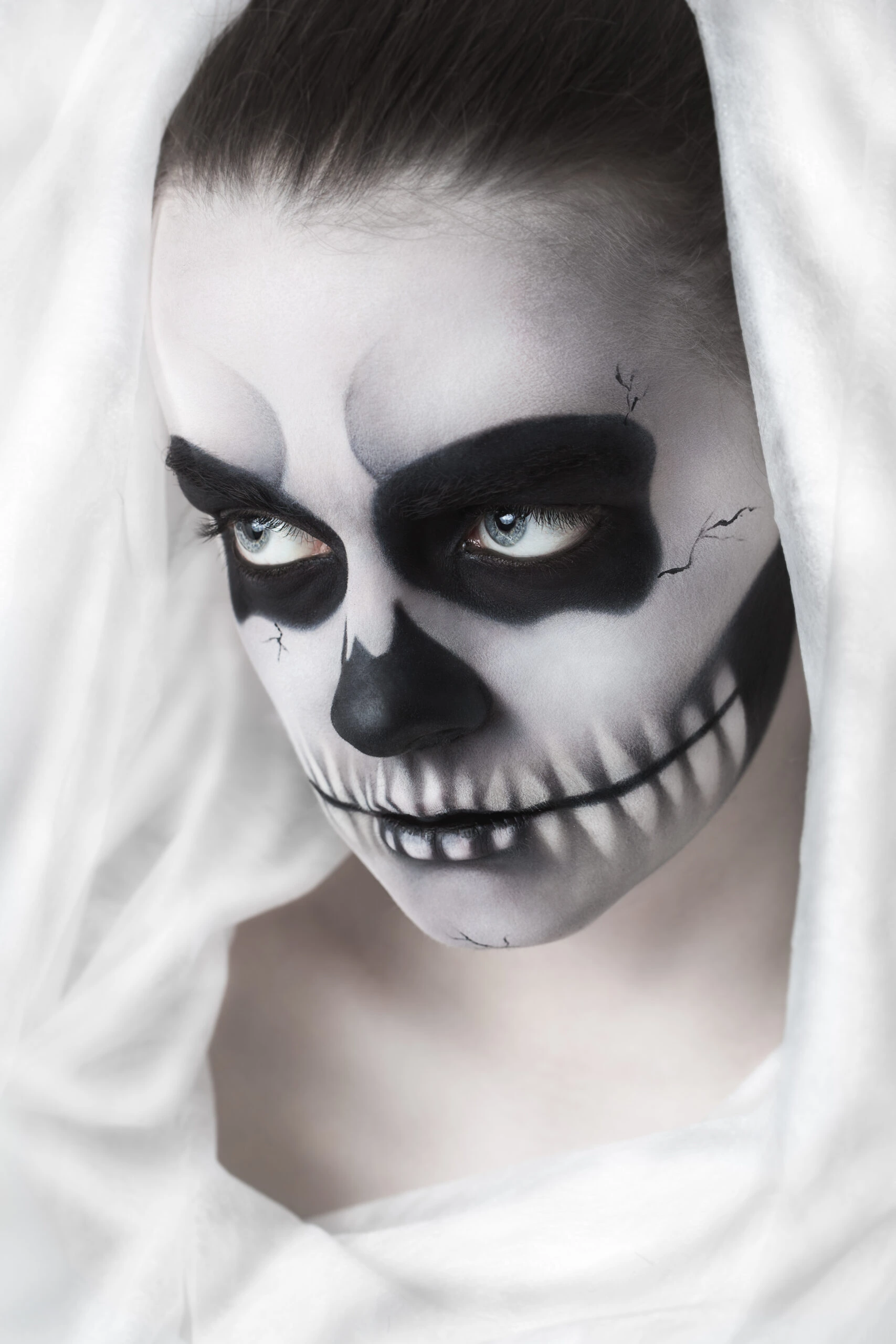 Woman with dramatic skull makeup symbolizing death, tied to Tattoos in the Metal Subculture.
