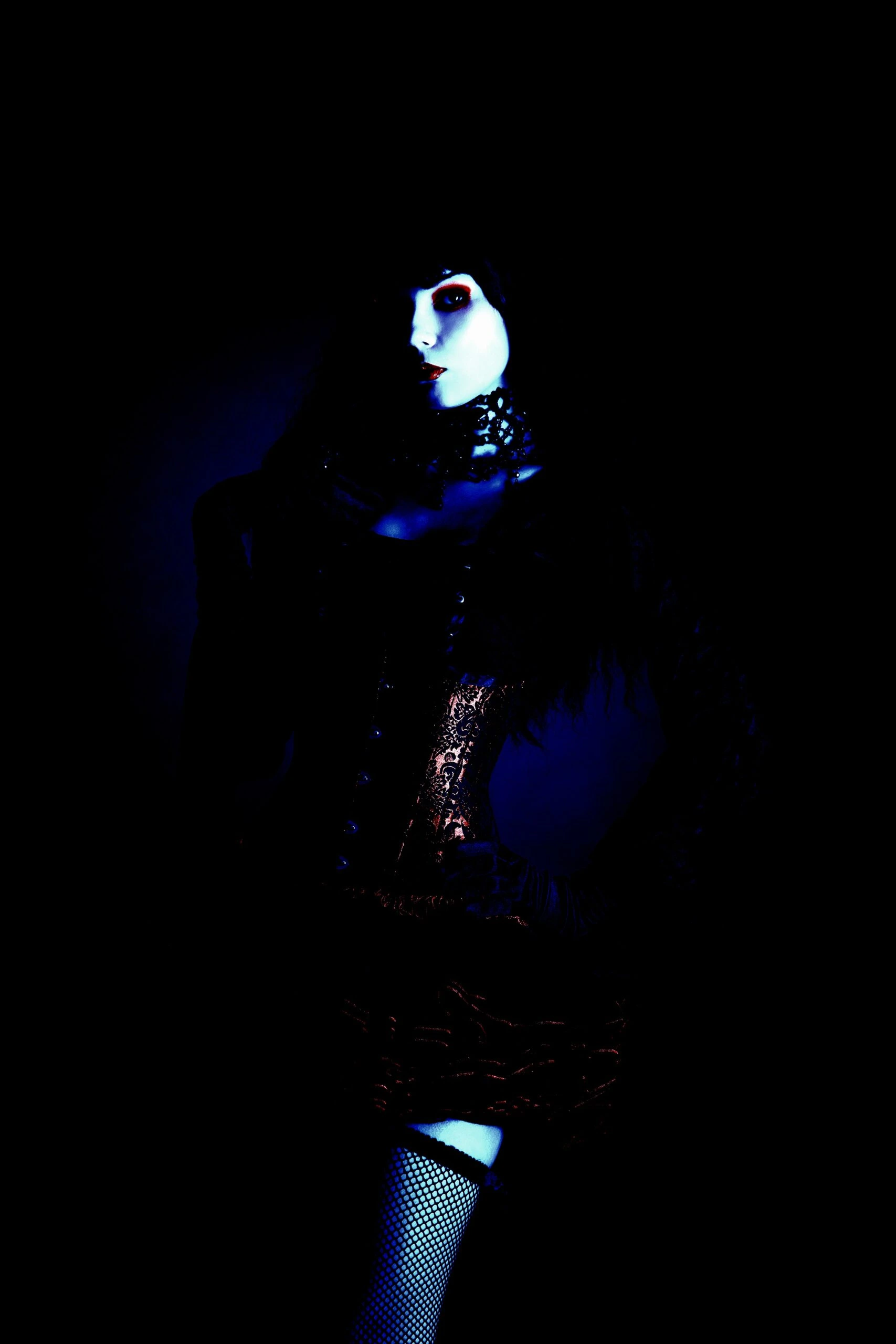 Dark portrait of a gothic woman in lace and corset, showcasing the Ultimate Gothic Ensemble.