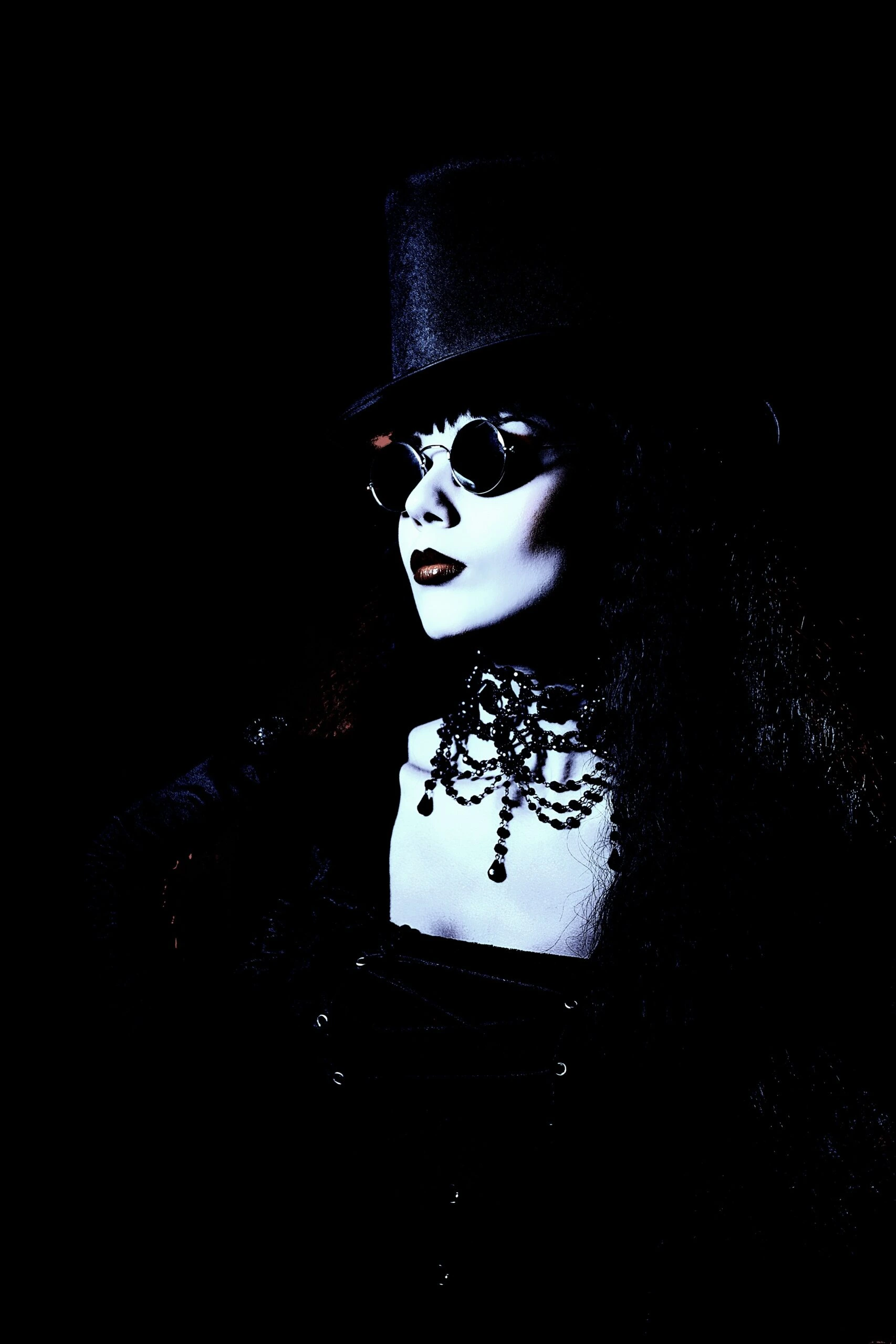 Wide shot of a gothic woman in top hat and corset, part of the Ultimate Gothic Ensemble.