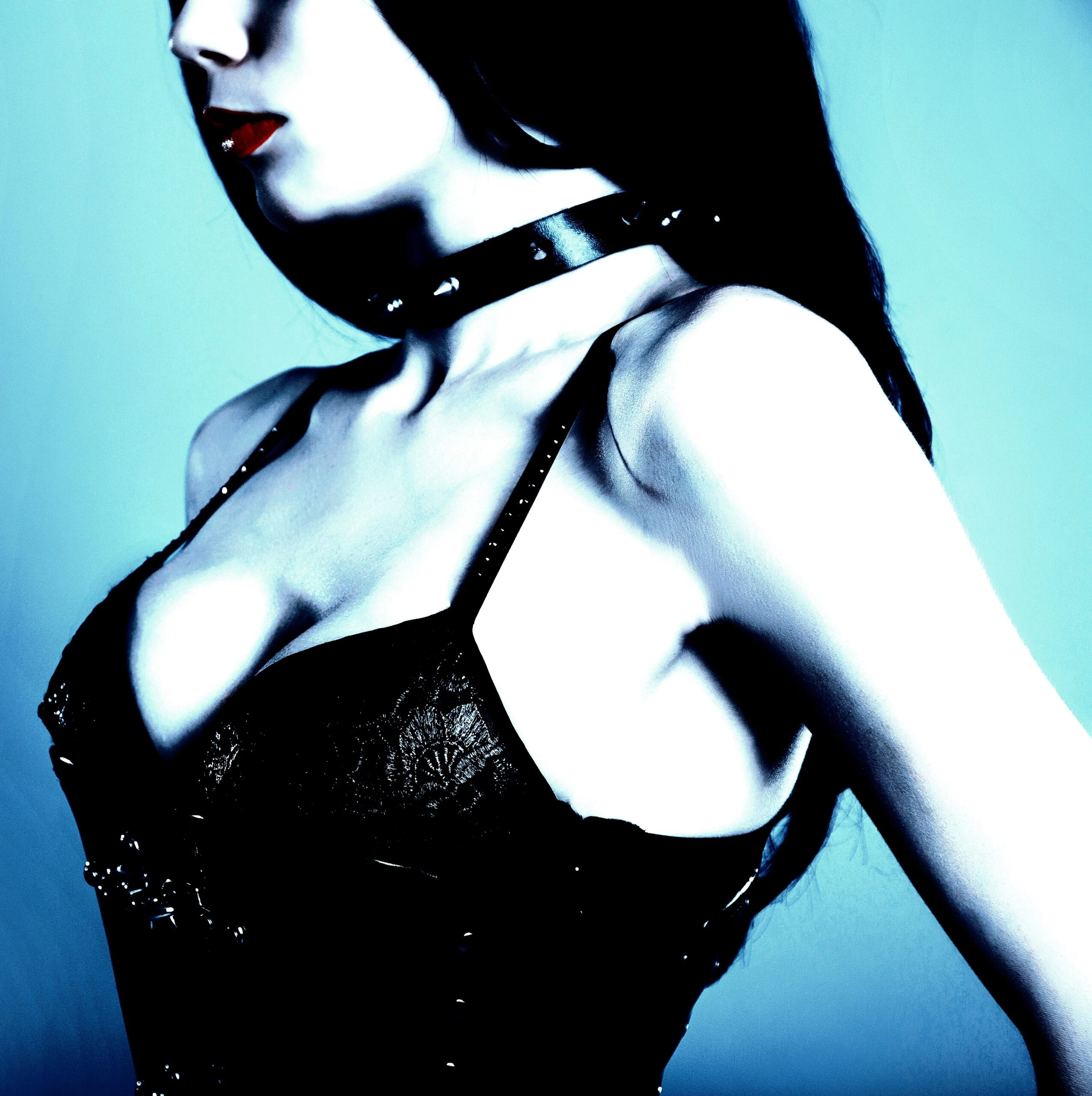 Elegant woman adorned with a Gothic jewelry snowflake obsidian gem necklace and dark makeup.