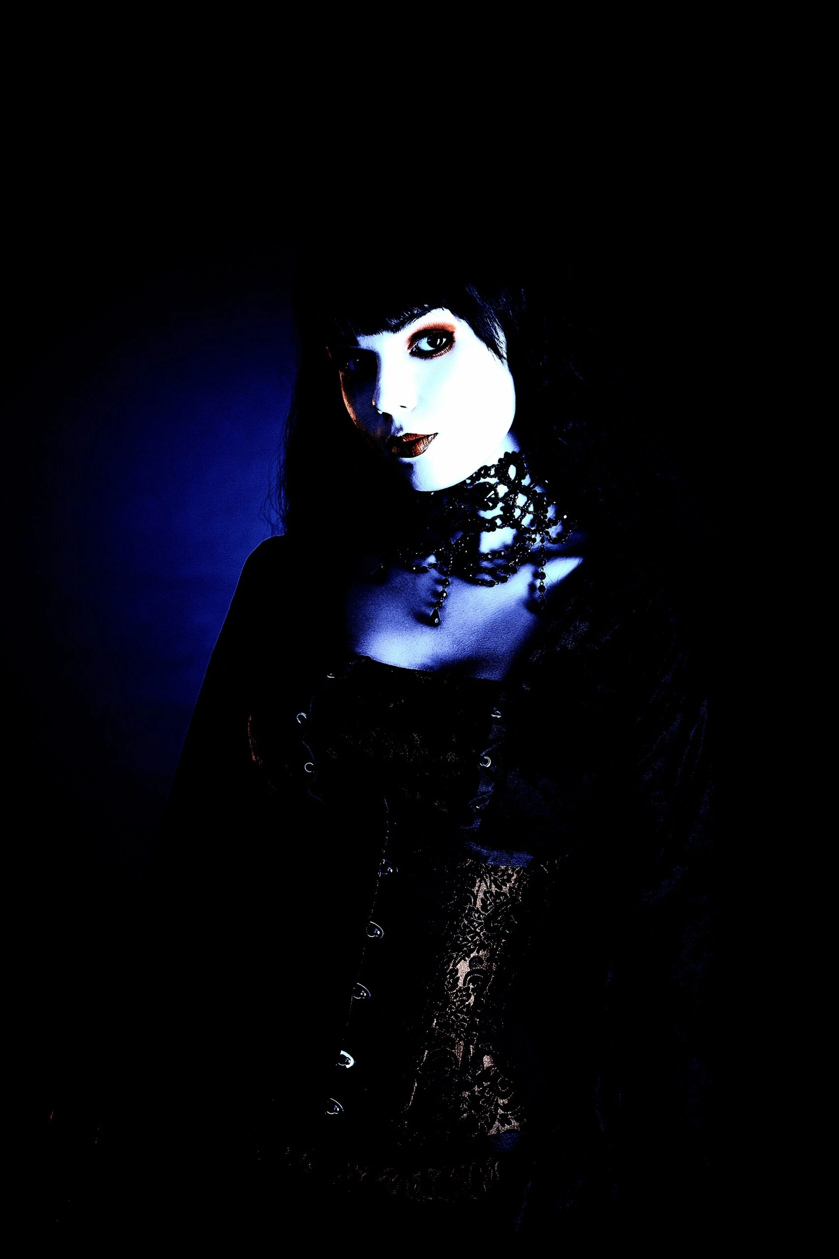Close-up of a gothic woman in dark makeup and elaborate gothic jewelry, part of the Ultimate Gothic Ensemble.