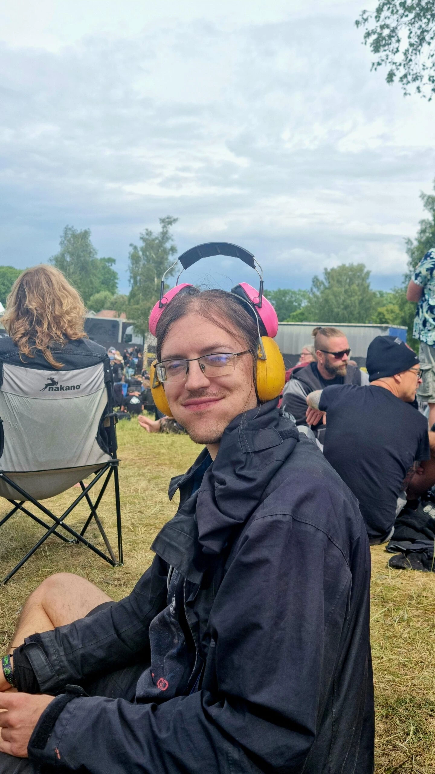 Man wearing ear protection and smiling at Sweden Rock Festival 2024