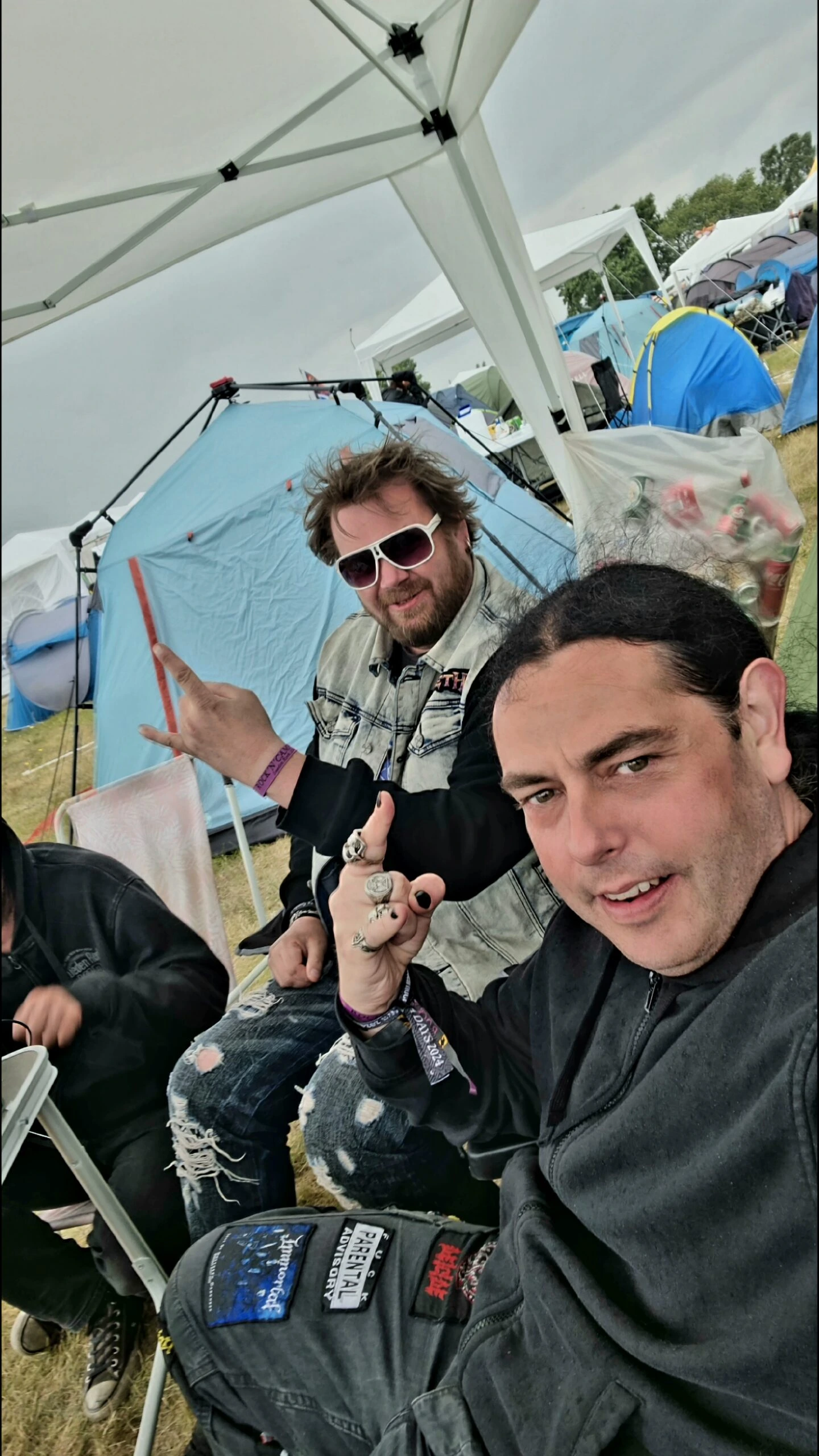 Two men making rock hand gestures at the campsite of Sweden Rock Festival 2024 Third Image: