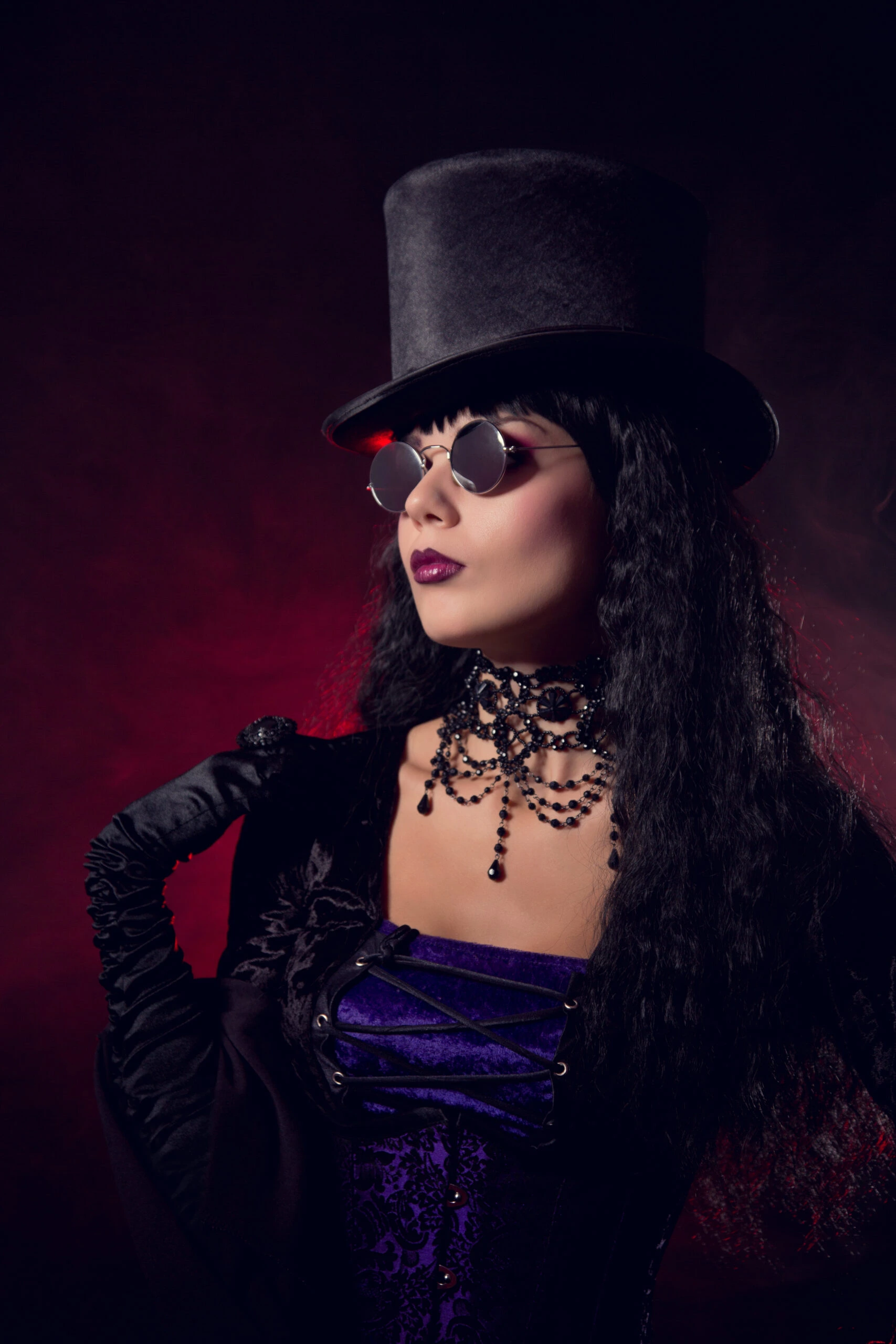 Gothic woman wearing a top hat and Witchy Fishnet Goth Mini Skirt Outfit with a choker necklace