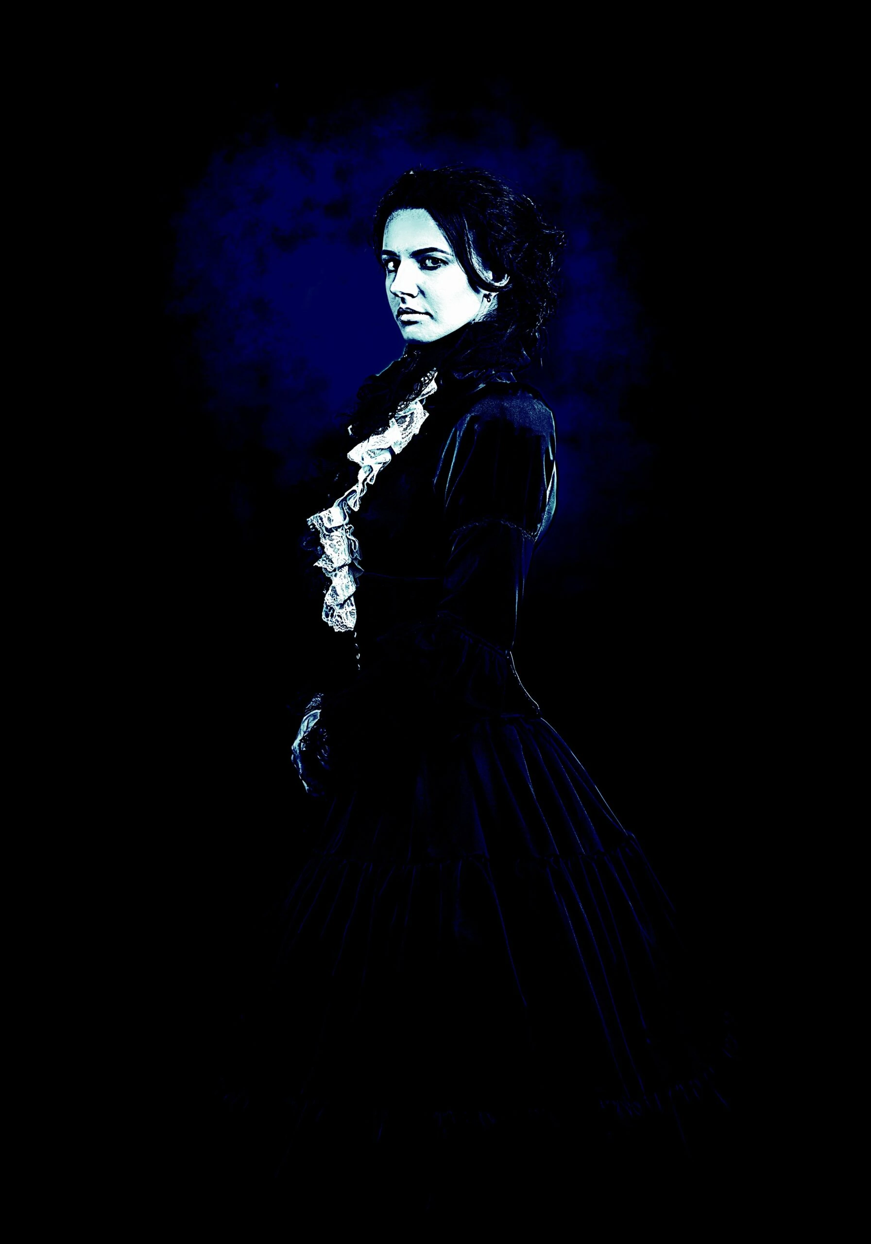 A gothic woman in a Victorian-inspired black dress with lace details, standing against a dark, misty background.