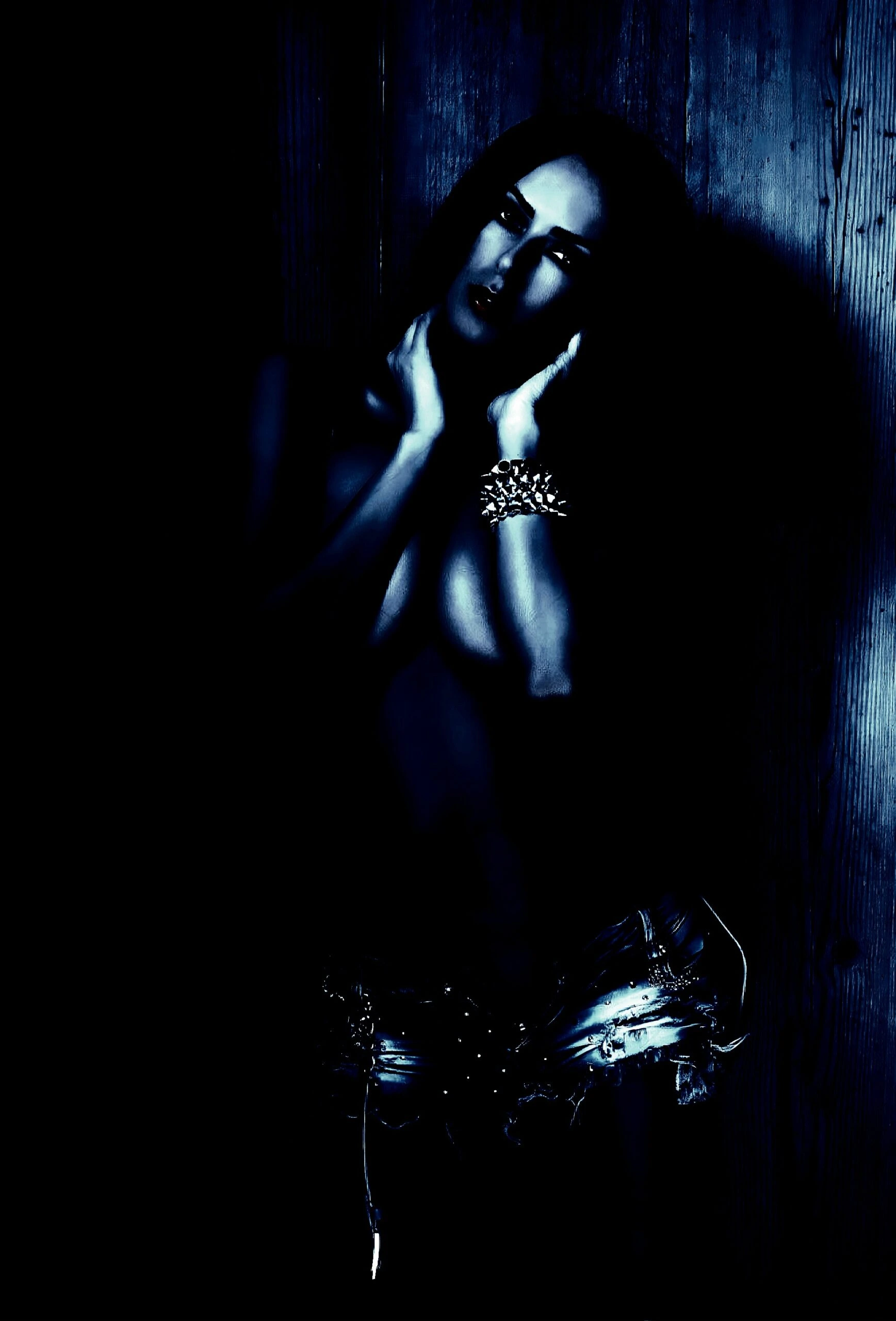 Woman with long hair in a contemplative pose, reflecting on BDSM practices.