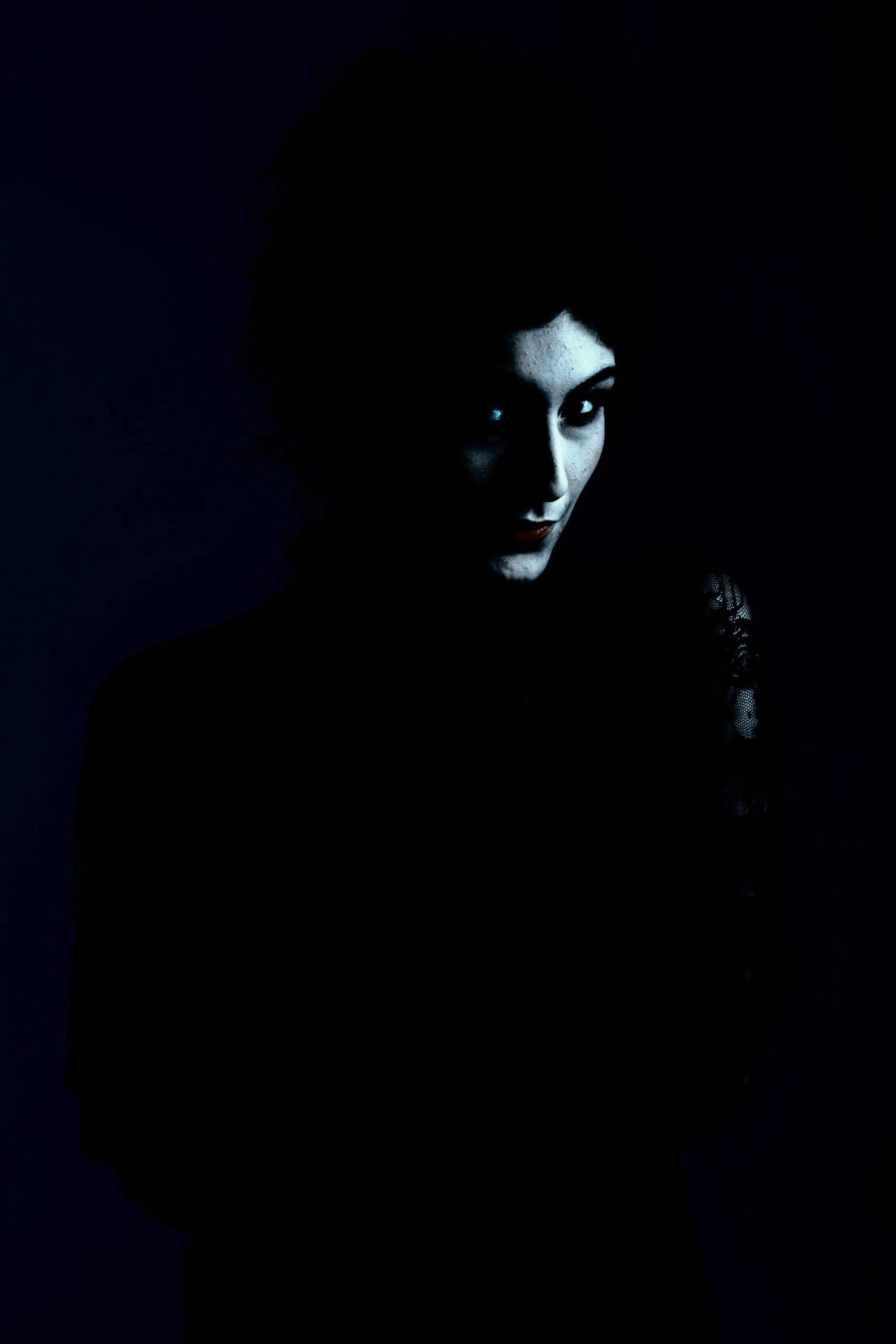 Dark and moody portrait of a gothic woman with a mysterious expression.