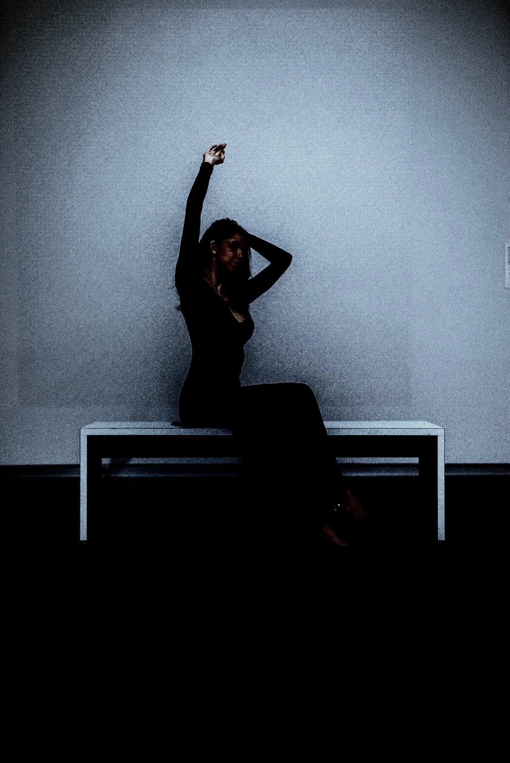 A person posing on a bench, showcasing BDSM practices with elegance and poise.