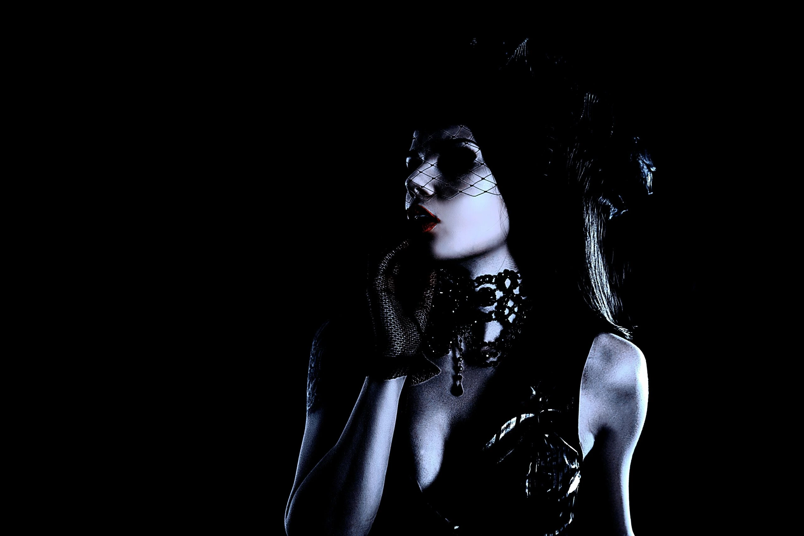 Gothic woman in a black outfit and top hat, partially obscured by smoke, creating a mysterious ambiance.