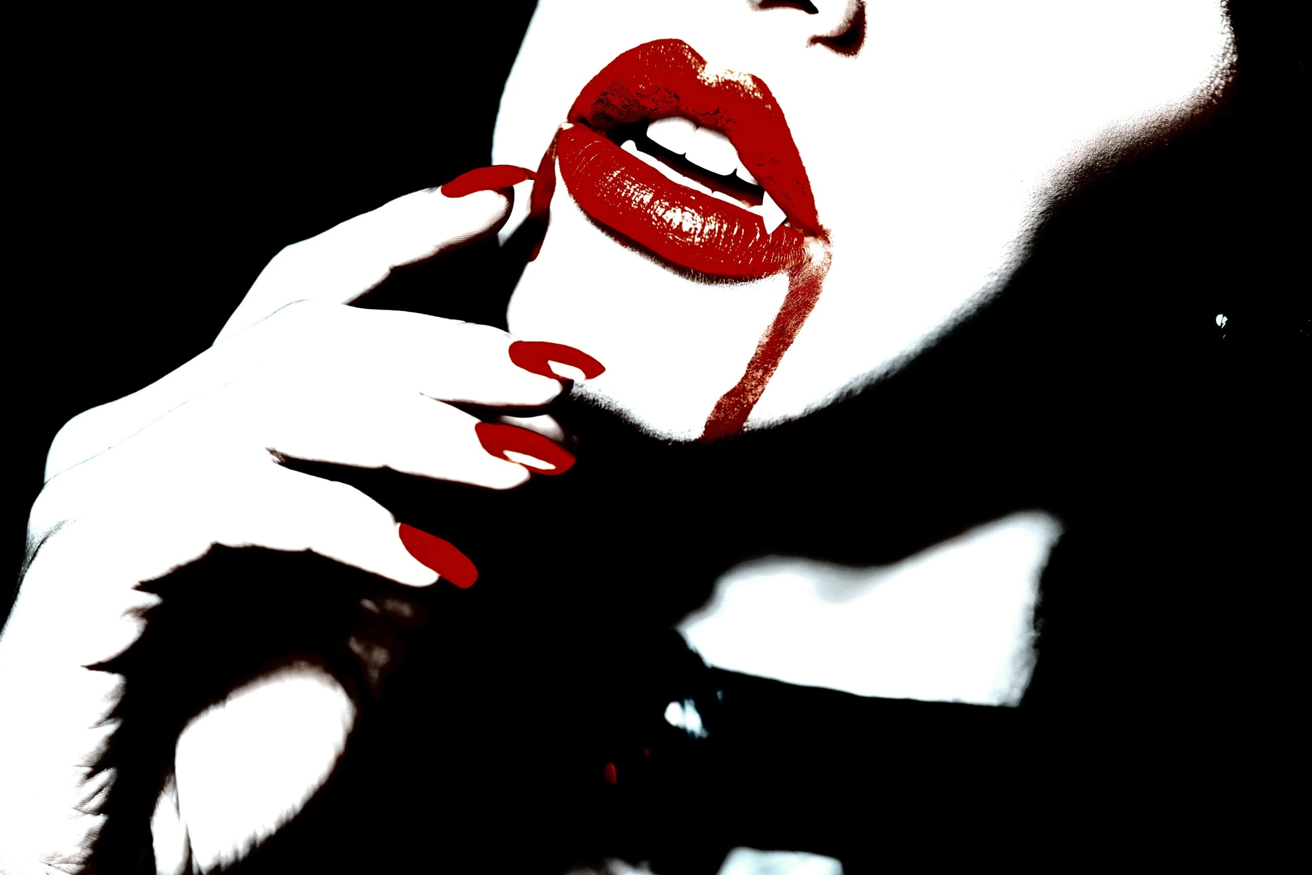 Close-up of a woman's red lips and nails with a hint of fangs, highlighting vampire goth velvet attire.