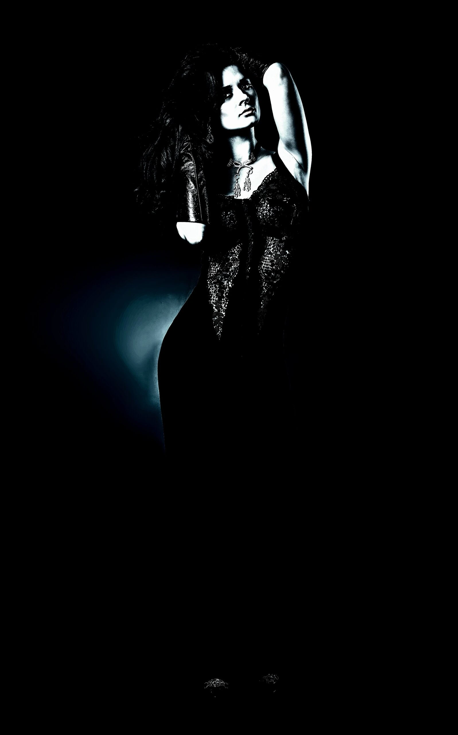 A gothic woman in a dark, lace gown standing confidently in a black void, exuding elegance and mystery.
