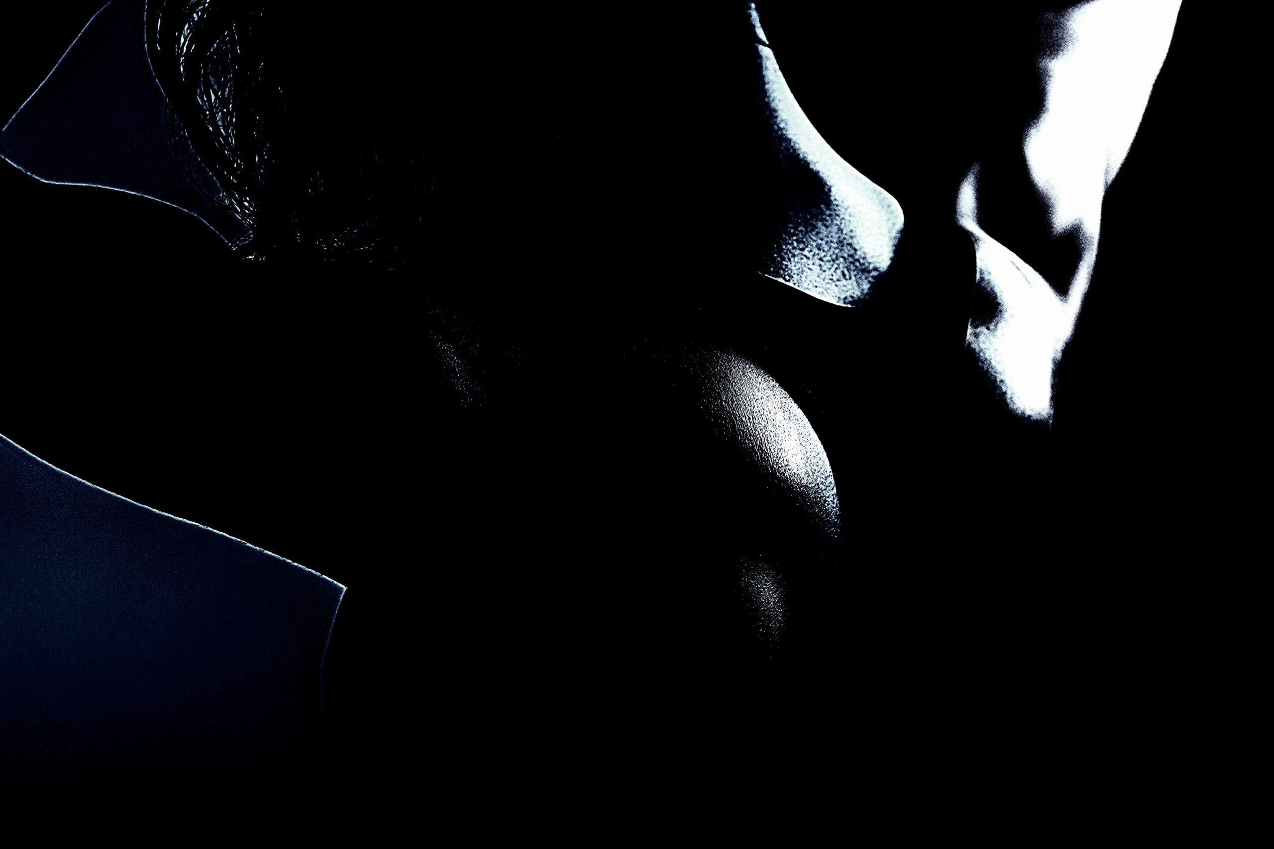 Woman in workout gear bending over with gym equipment and neon lights in the background