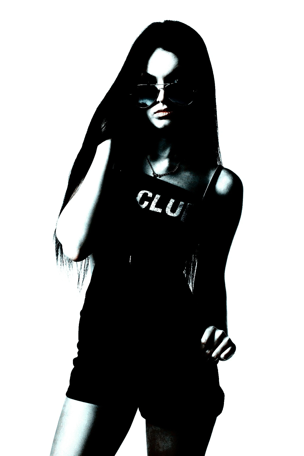 Woman in a crop top and shorts, with sunglasses and long hair, posing confidently.