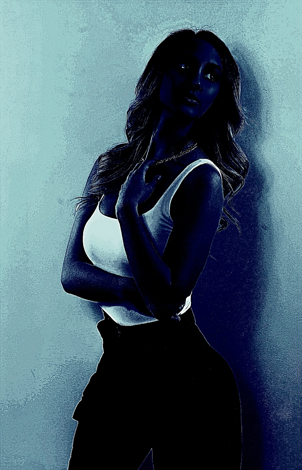 Woman in a tank top, posing with one hand on her chest, in a blue-toned image.