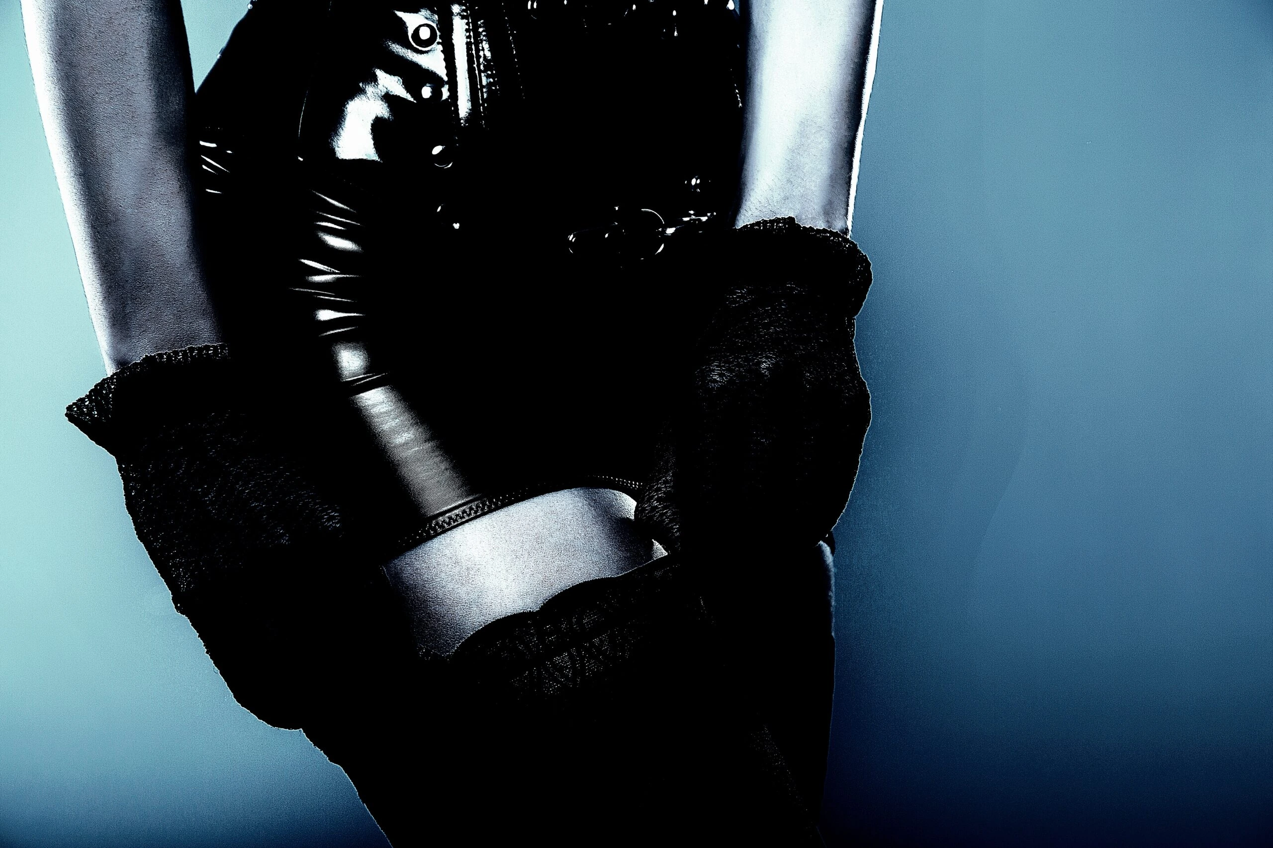 Close-up of a woman's torso in a skirt with lace detailing and a glove on her shoulder, showcasing the elegant design.