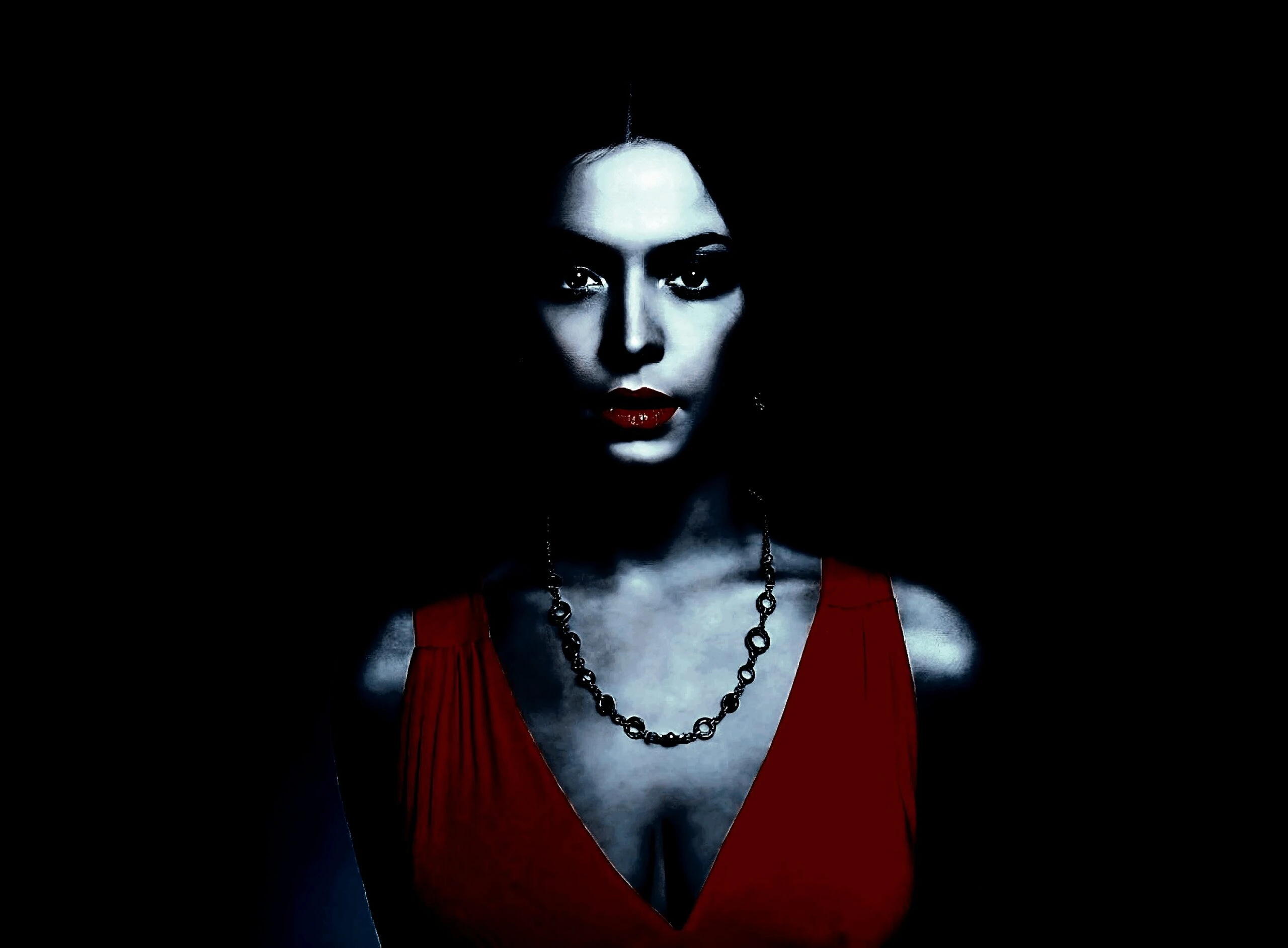 Dramatic portrait of a woman in dark lighting, wearing a red dress, capturing a gothic and mysterious aura. 
