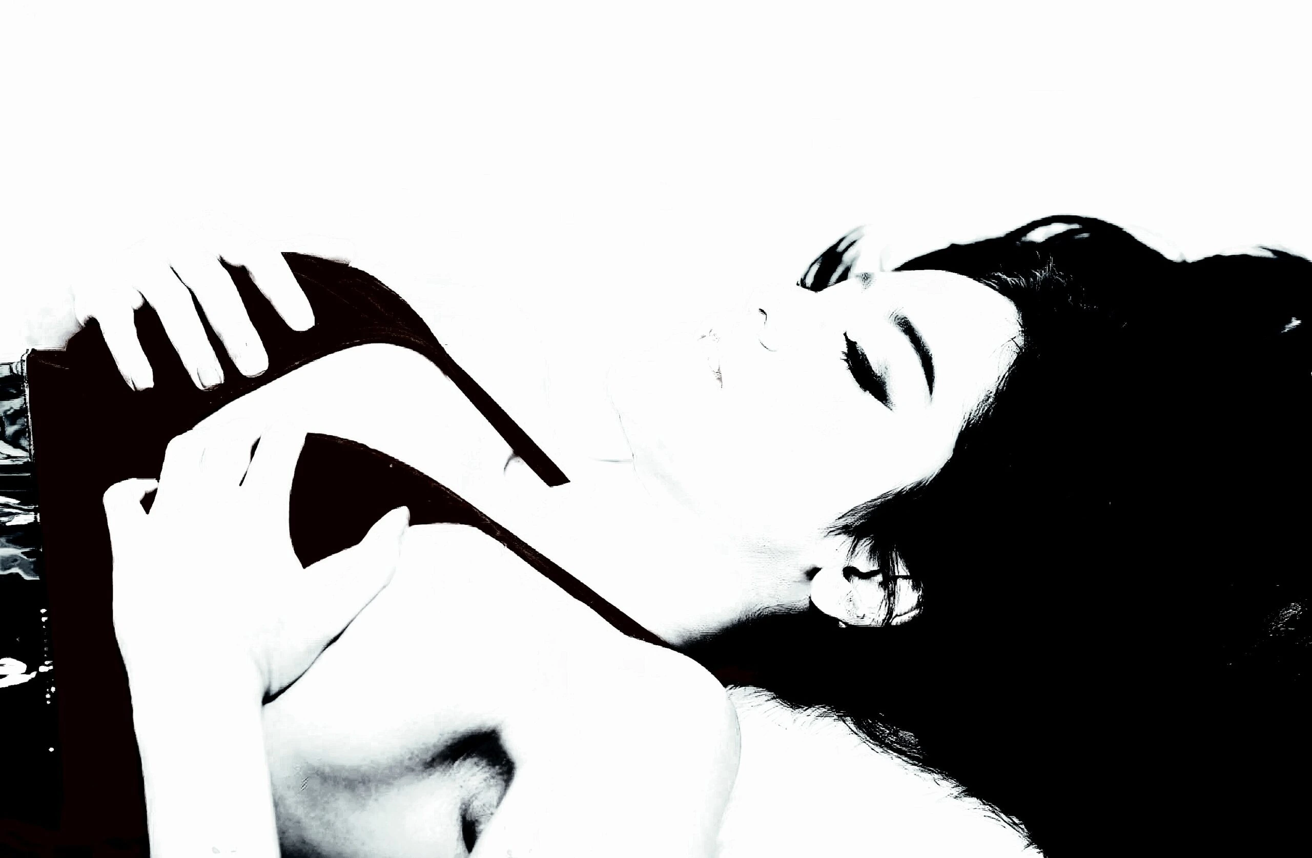 A high-contrast artistic shot of a woman lying down in black lingerie, evoking mystery and allure.