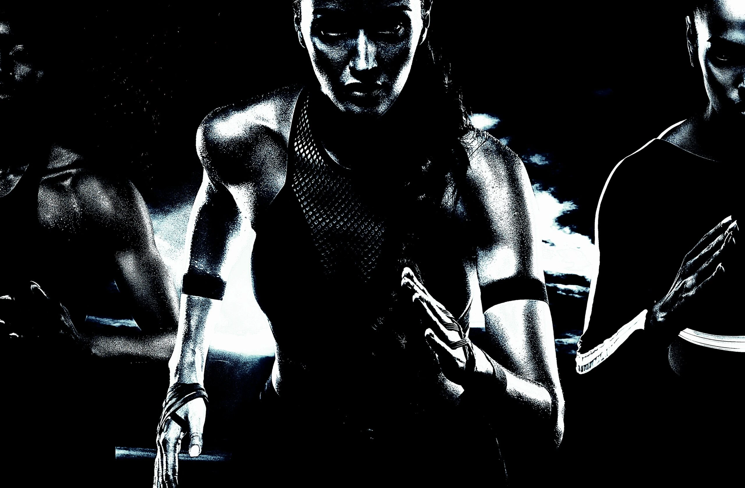 Group of women sprinting in a high-intensity workout, featuring powerful body movements and strong muscular definition.