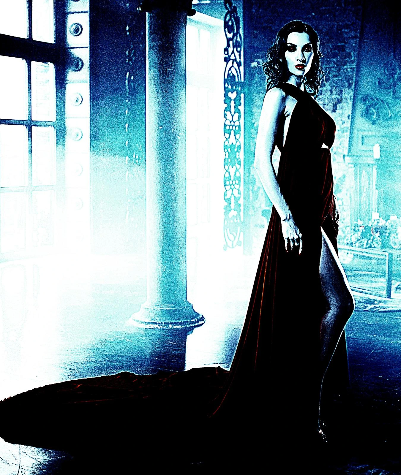 Elegant woman in a deep red gown with a thigh-high slit, standing in an atmospheric, dimly lit room.