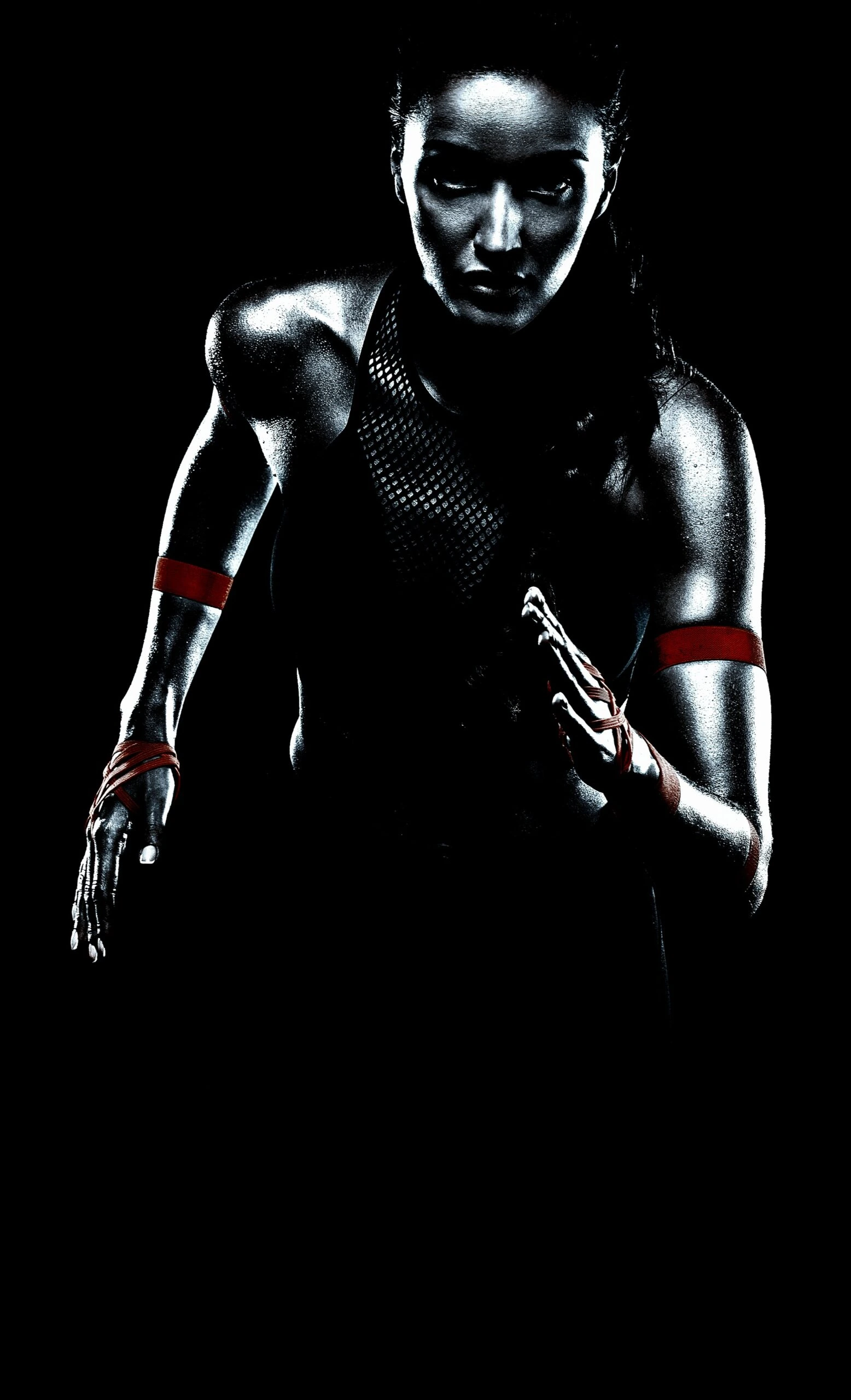 Athlete in mid-run, highlighting intense focus and strength, with muscles accentuated by low lighting, ready for action.