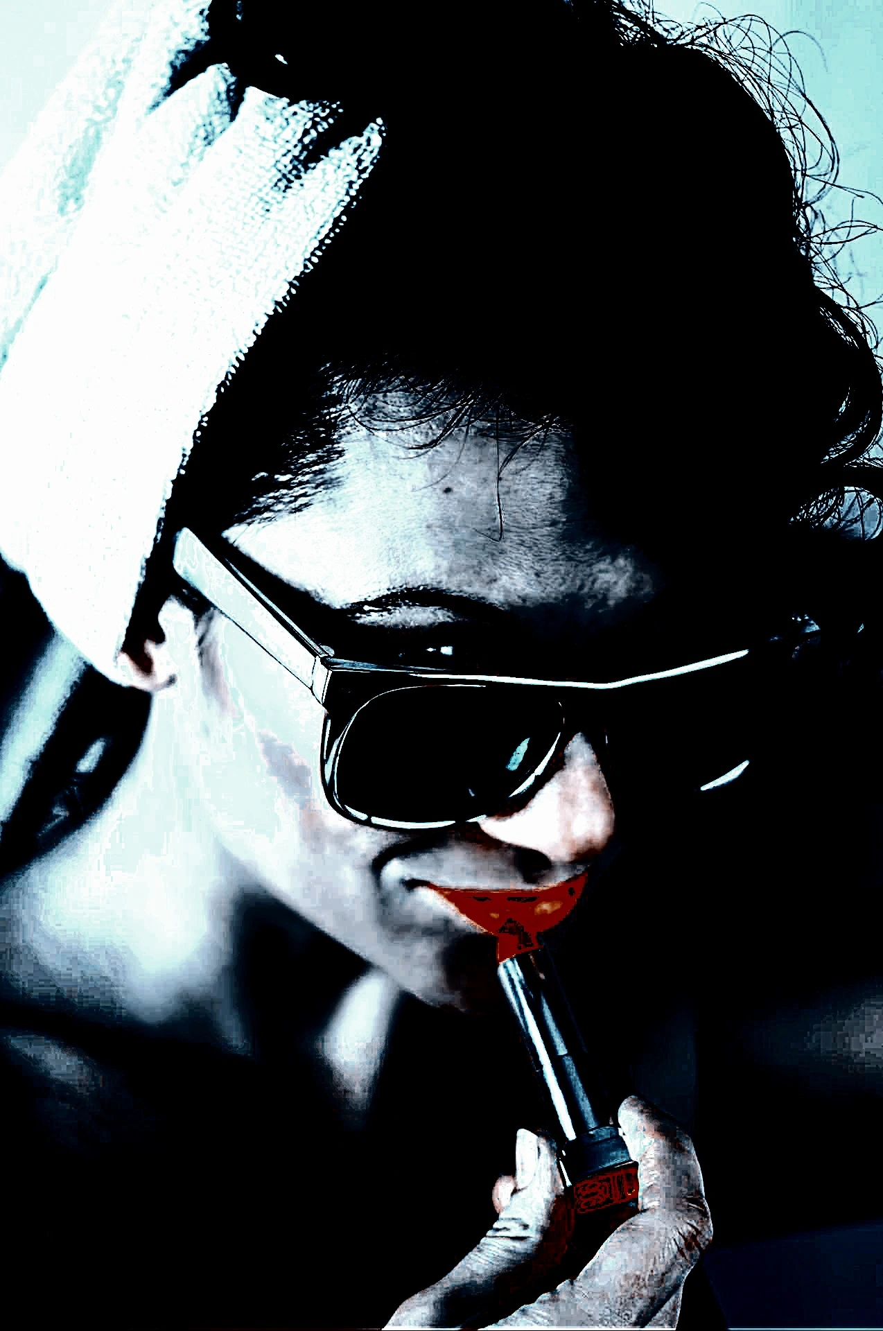Woman in oversized black sunglasses and dark attire, striking a mysterious pose in an outdoor setting.