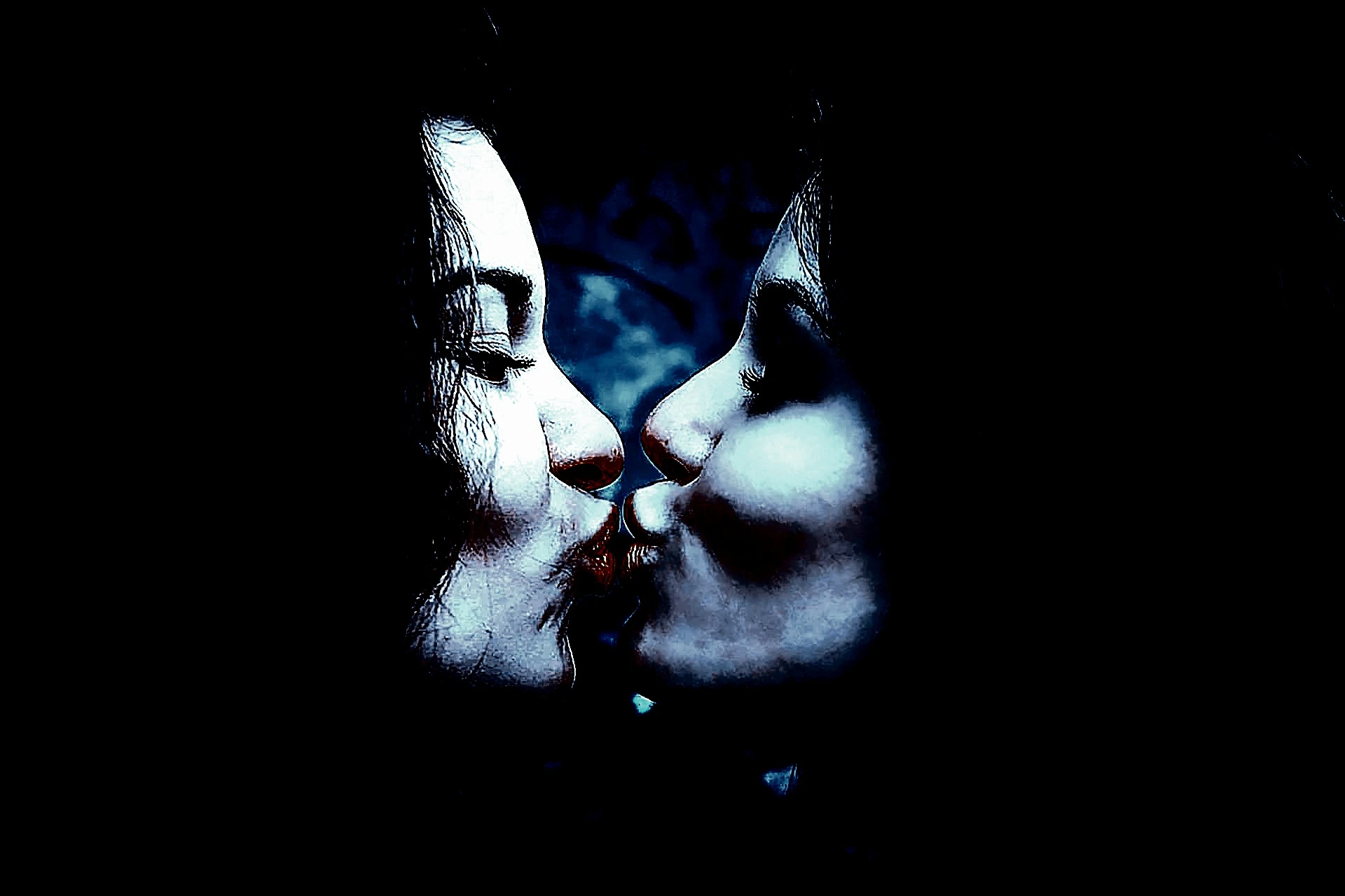 Two women sharing an intense kiss in dim lighting, highlighting their facial expressions and creating a dark, intimate atmosphere.