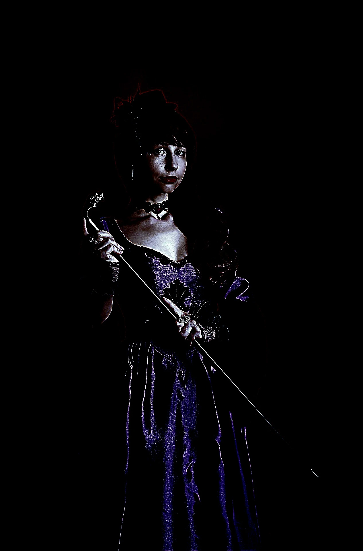 Gothic woman in a Victorian dress holding a cane, with a fierce and commanding presence.