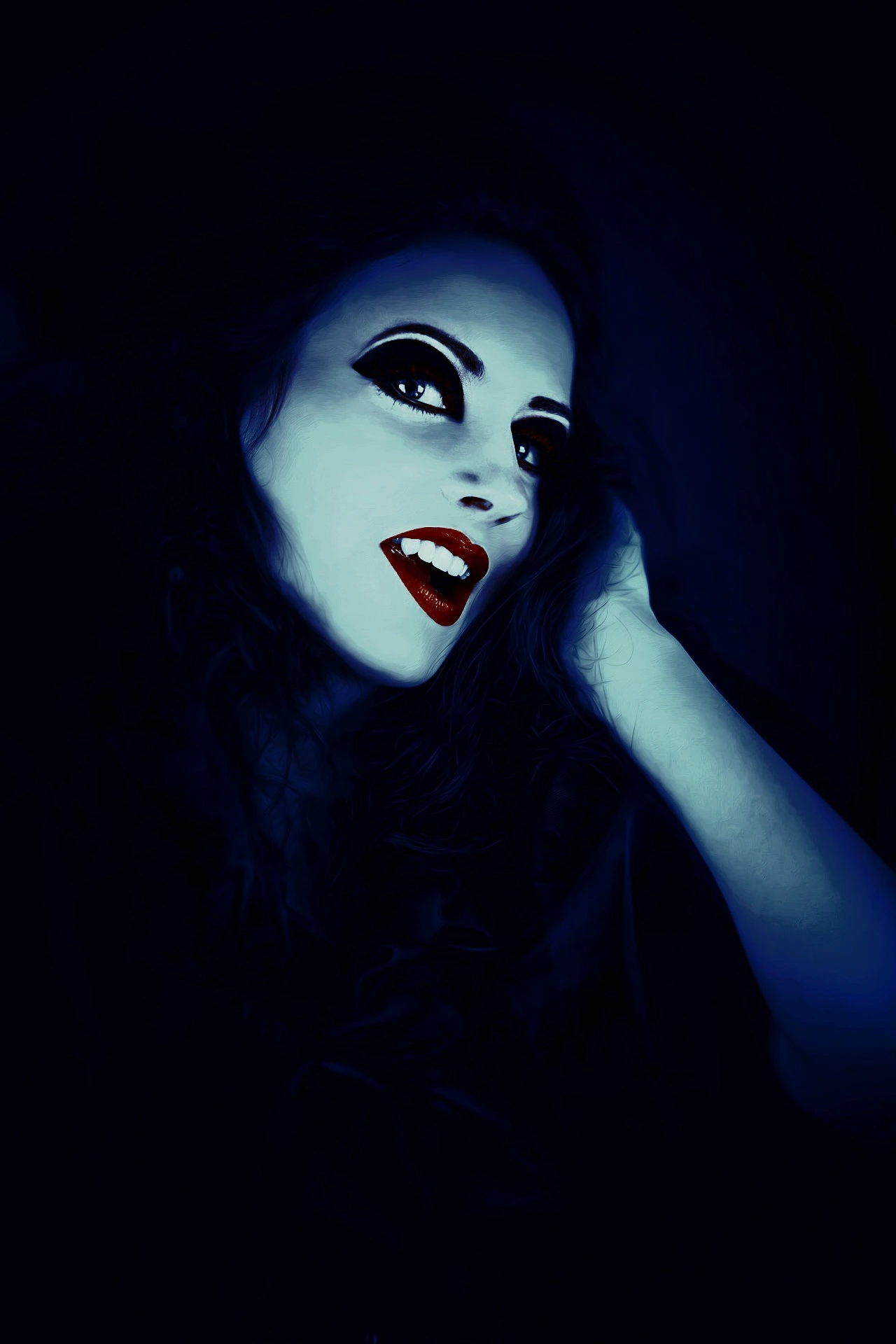 Vampire woman with piercing eyes, dark makeup, and red lips, smiling mysteriously in dim blue lighting.