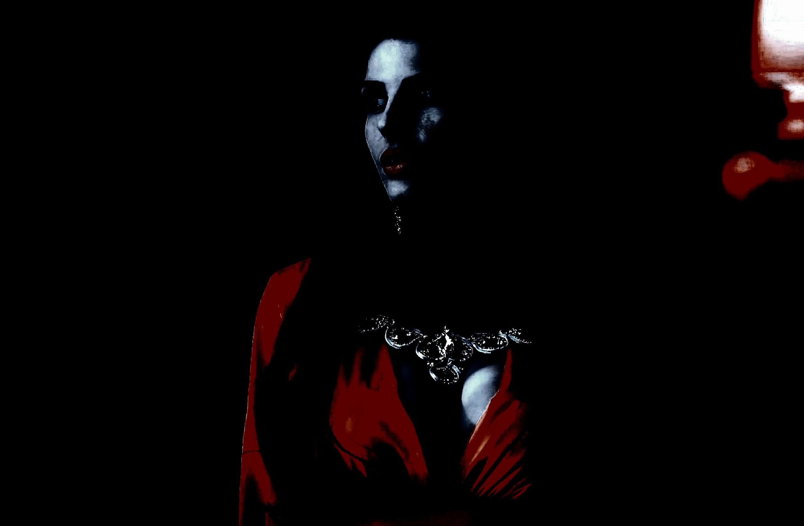 Portrait of a woman in a red dress with dramatic shadows, highlighting elegance and allure.
