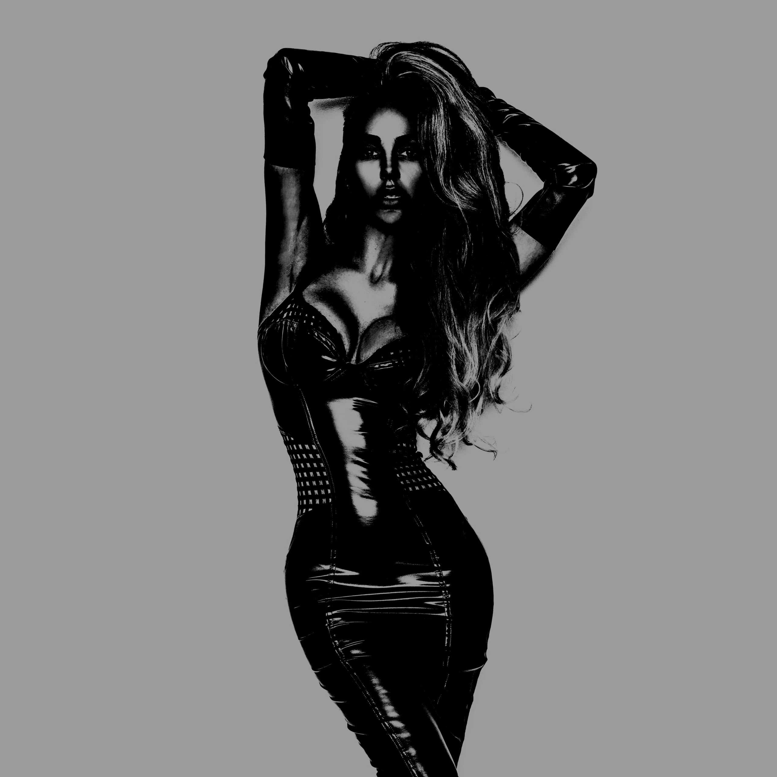 A striking woman in a sleek black vinyl dress with dramatic lighting, exuding bold confidence and mystery.