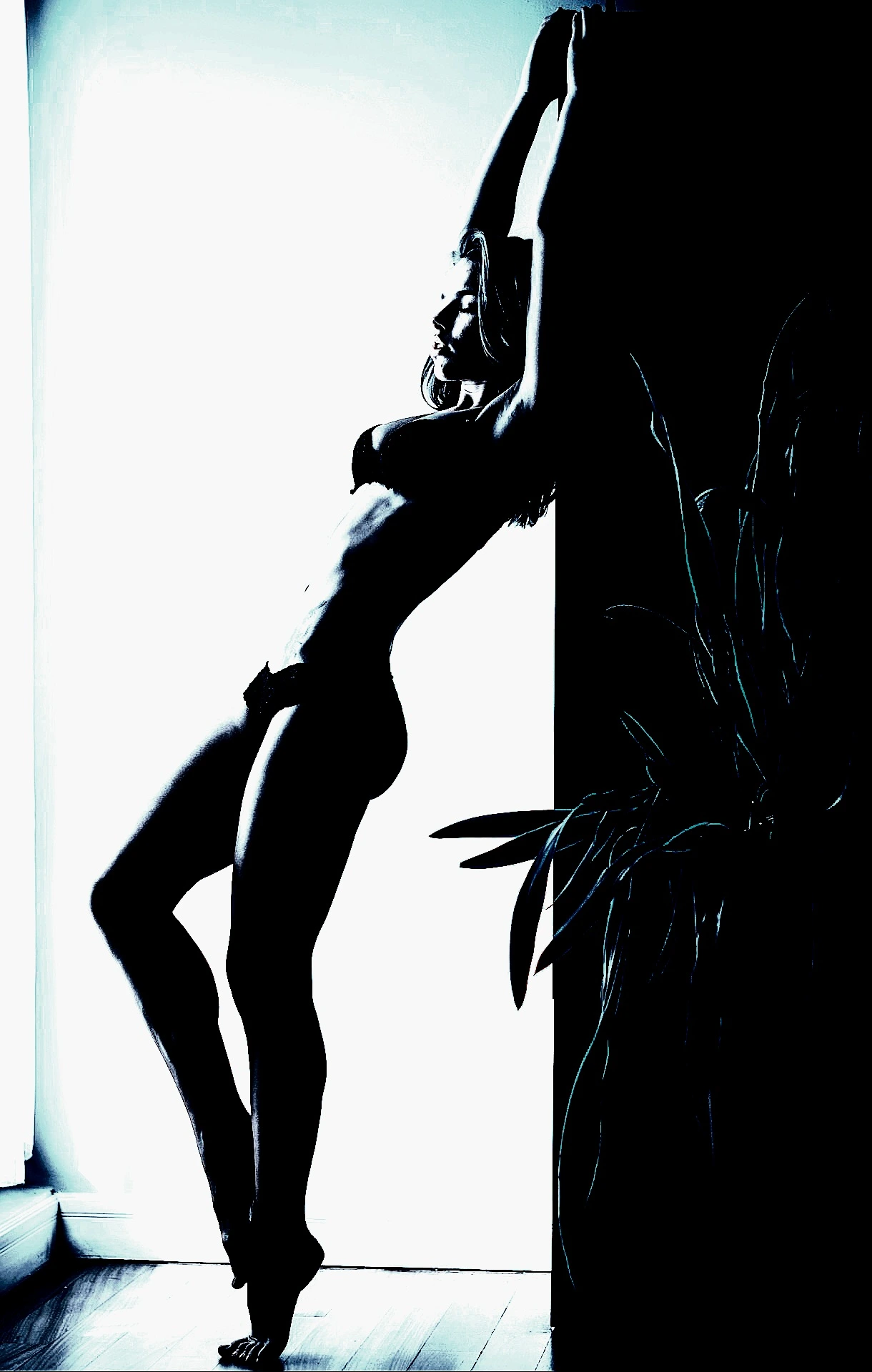 Fit woman stretching against a wall, showcasing toned muscles in a dynamic pose, bathed in blue-tinted lighting.