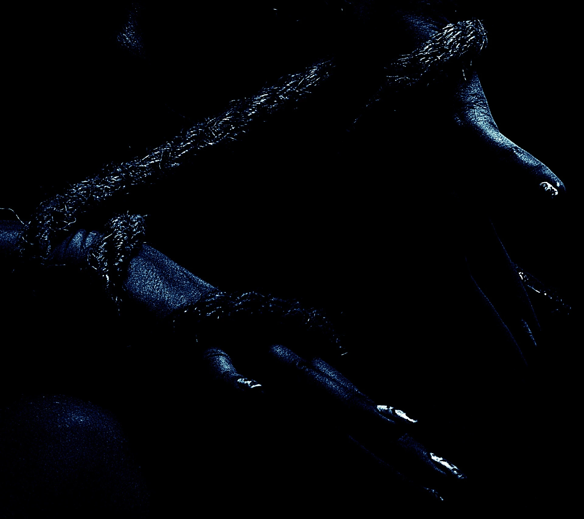 Hands bound tightly with rough rope, fingers slightly curled in a low-light setting.