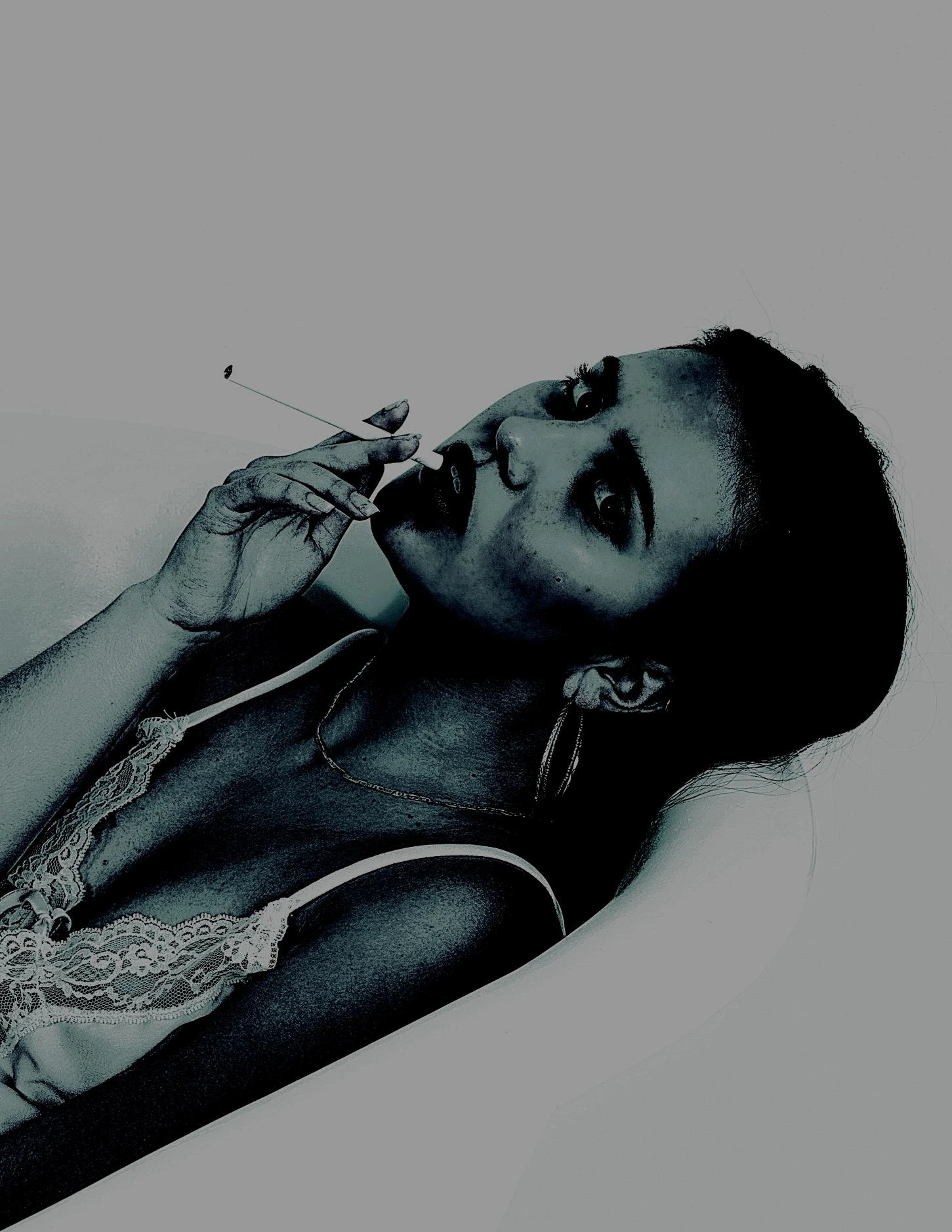 Sultry woman in lace lingerie lounging in a bathtub, smoking a cigarette with a dark, intense gaze.