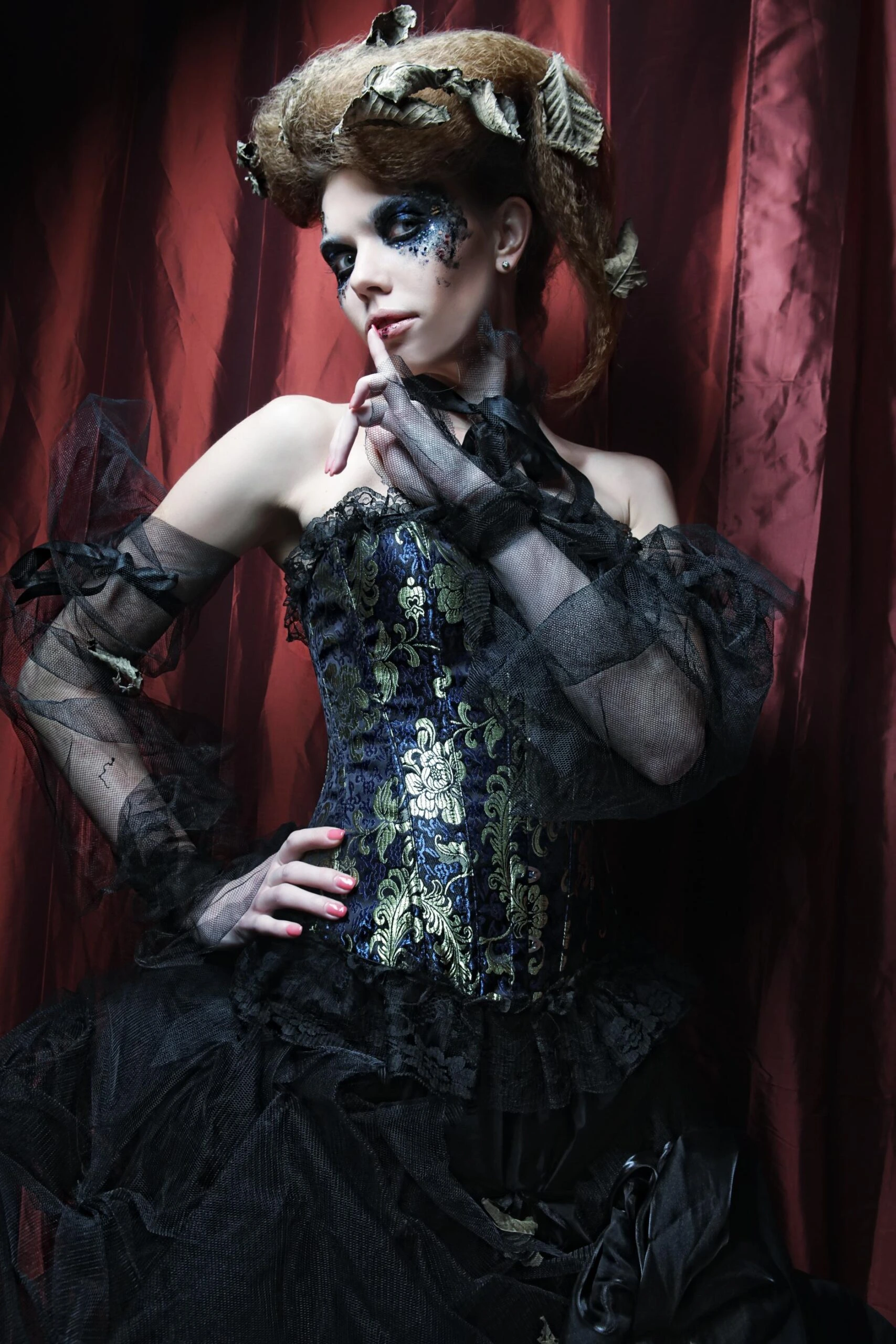 Gothic-inspired corset with intricate brocade patterns and sheer tulle, styled in a dramatic Victorian aesthetic.