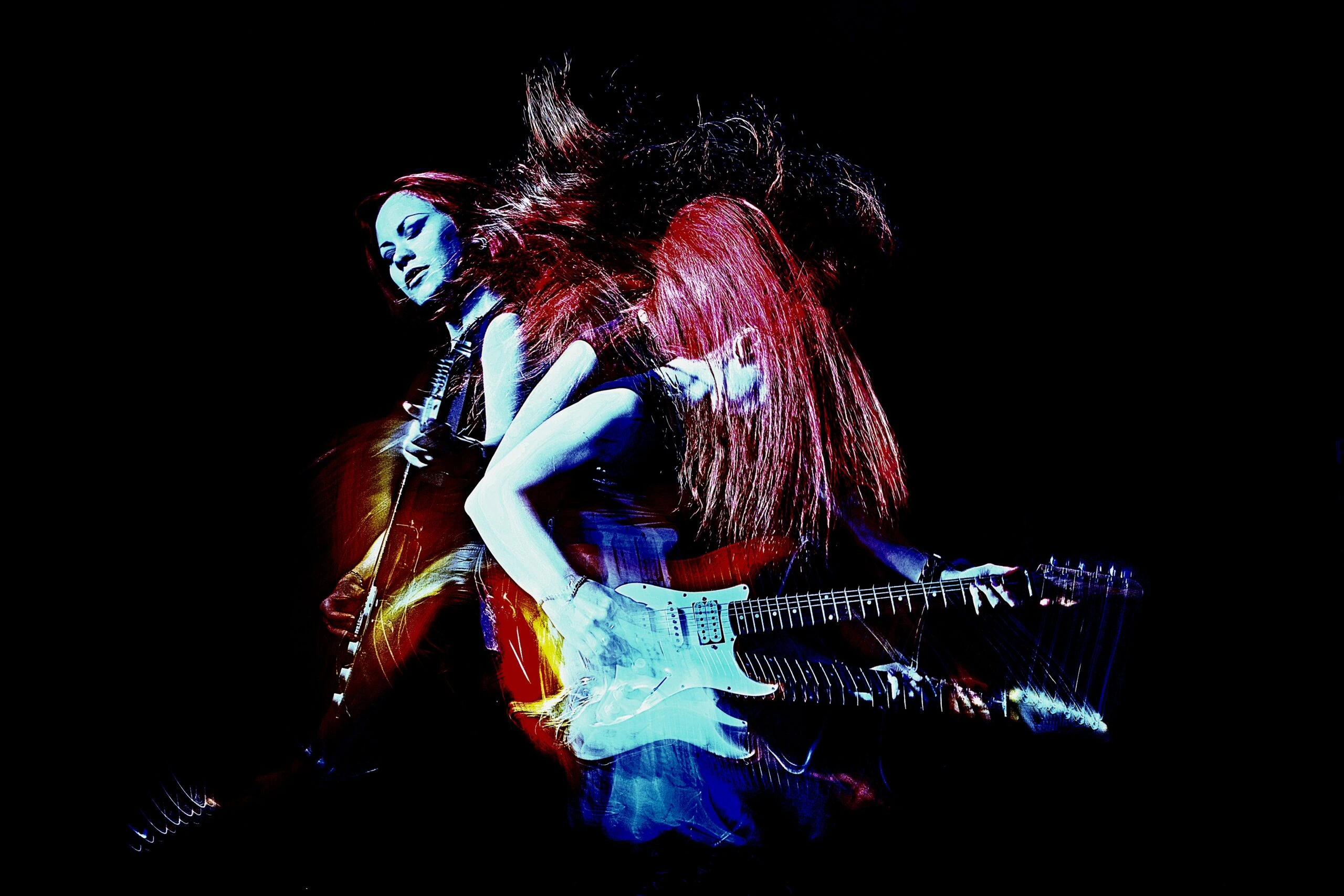 Double-exposure image of a woman playing electric guitar with vibrant red and blue lighting effects.
