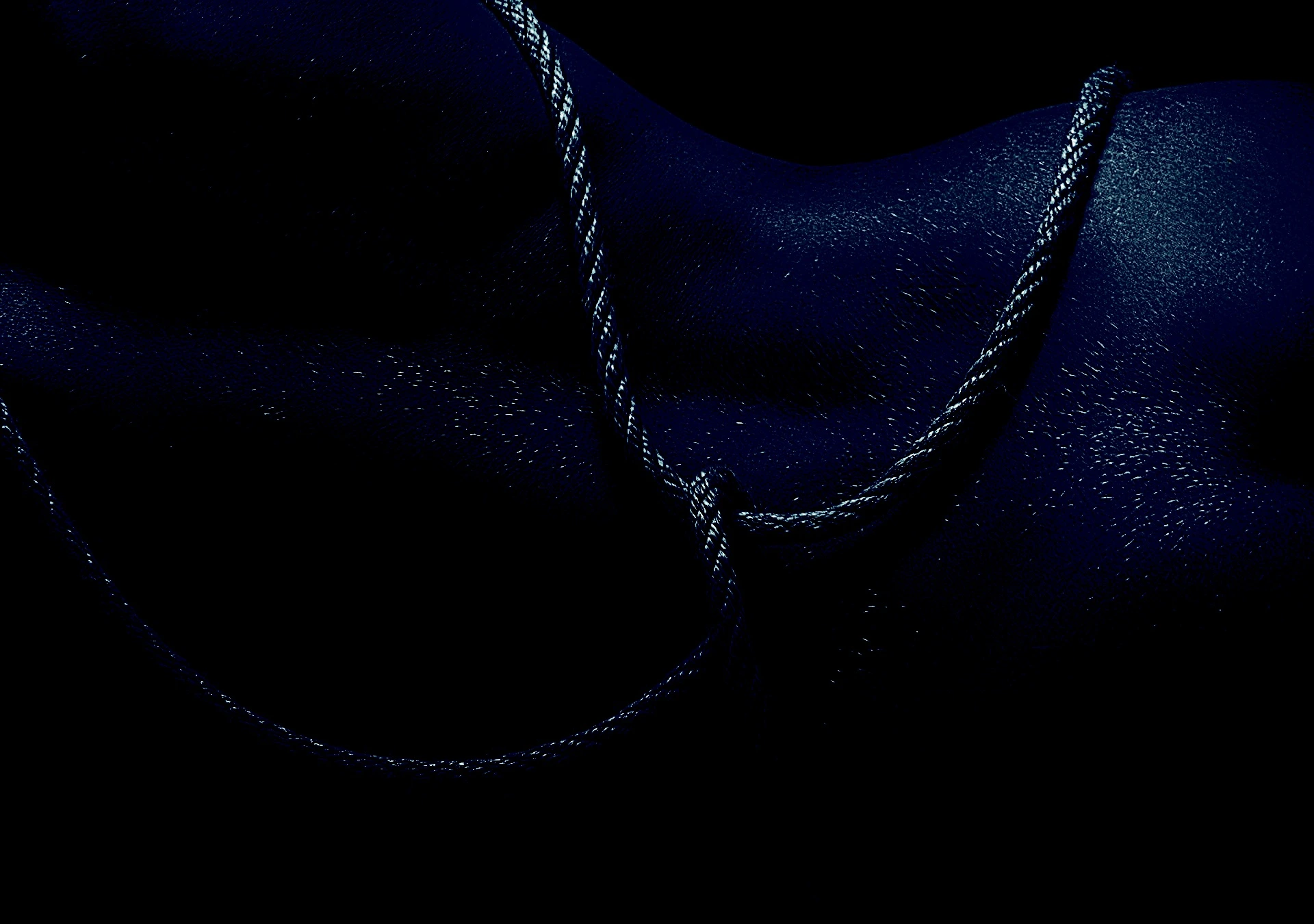 Close-up of rope against bare skin, emphasizing texture and tension in deep shadow