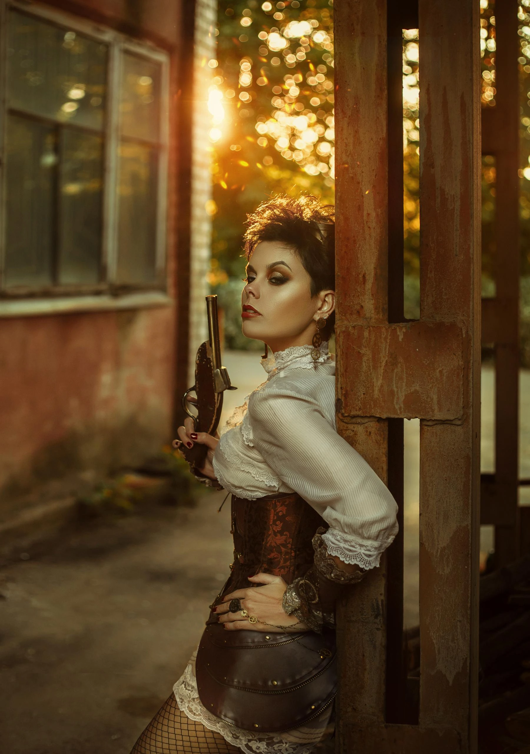 Steampunk-inspired woman leaning against a wall in a brown corset, holding a vintage pistol at sunset.