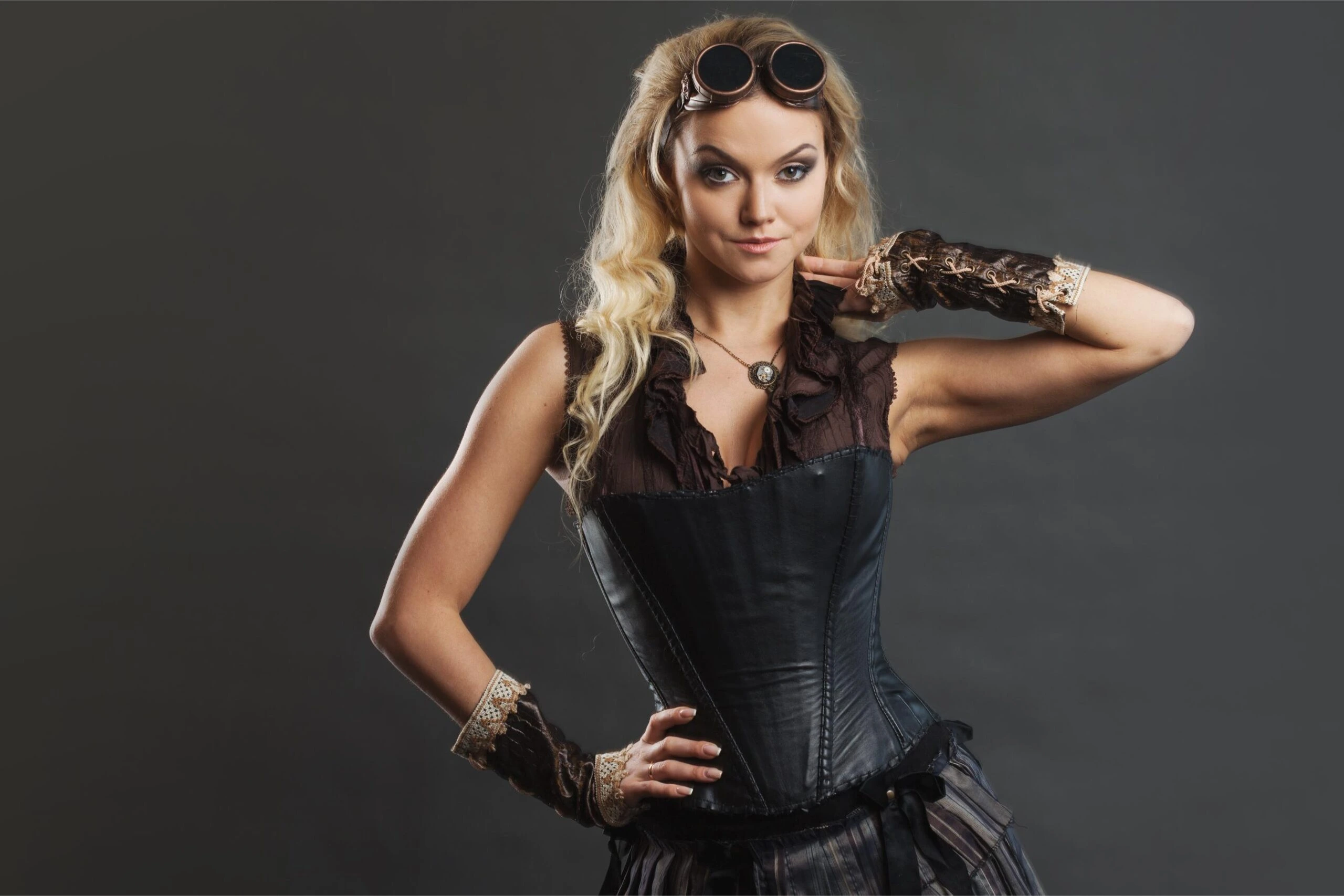 Woman wearing a black corset and long skirt in a forest setting, showcasing structured fit and waist-cinching design